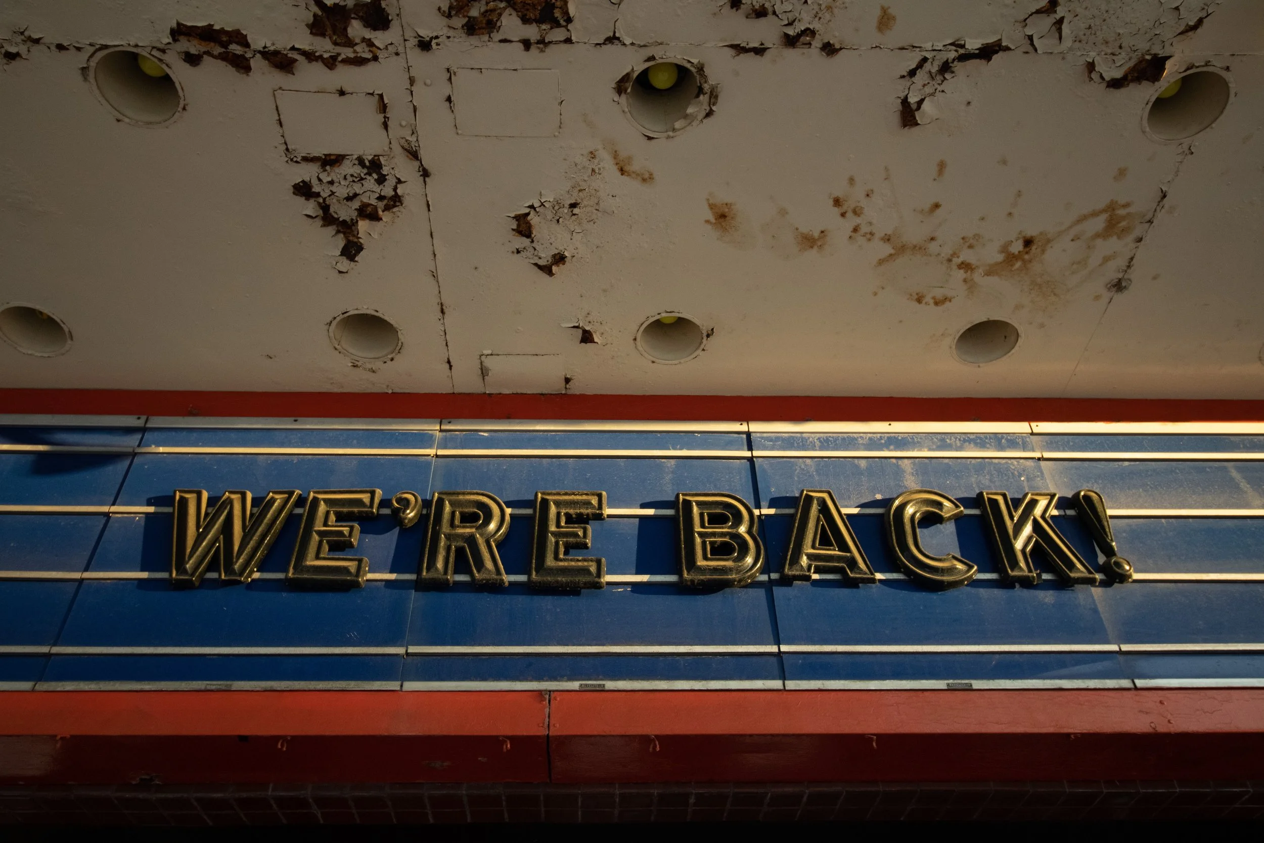 WE'RE BACK, rust-stained canopy, blue tile, Oriental Theater, Denver, CO