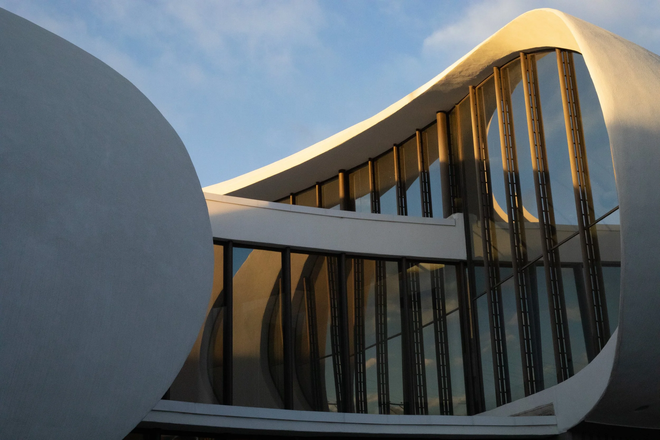Curved concrete and glass facade early morning light, Englewood, CO