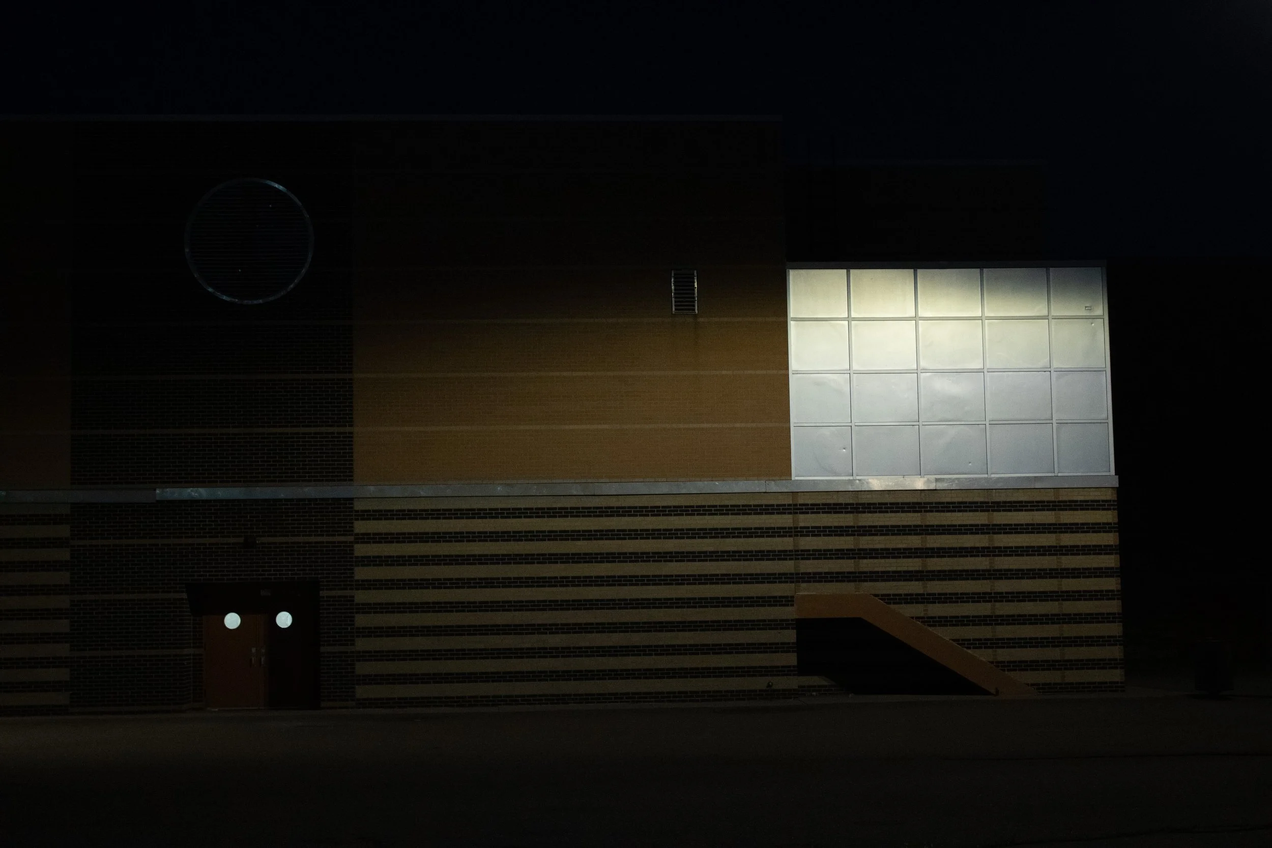 Striped brick wall with reflecting light, Abraham Lincoln High School, Denver, CO