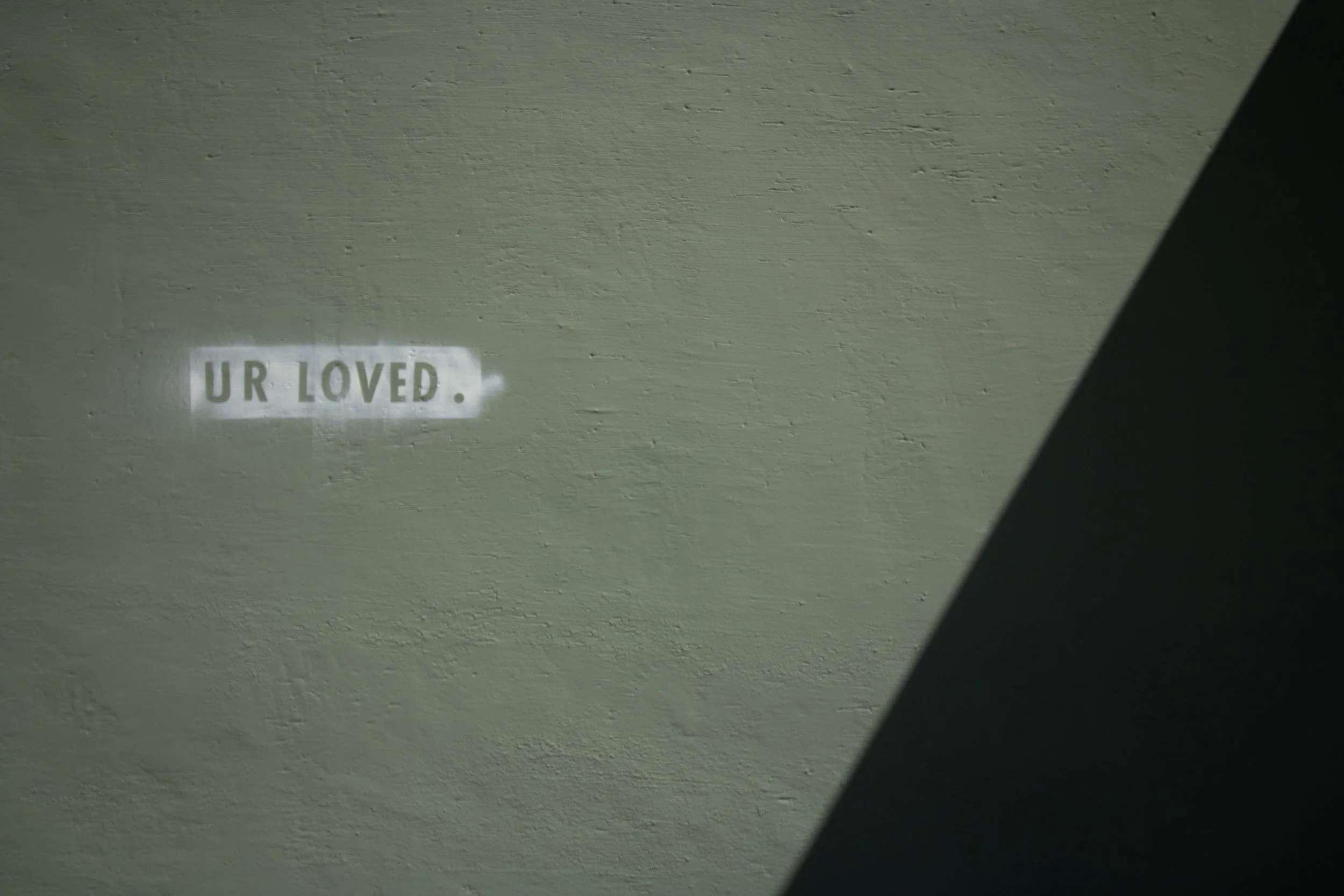 UR LOVED, sage green wall, diagonal shadow, Cortez, CO