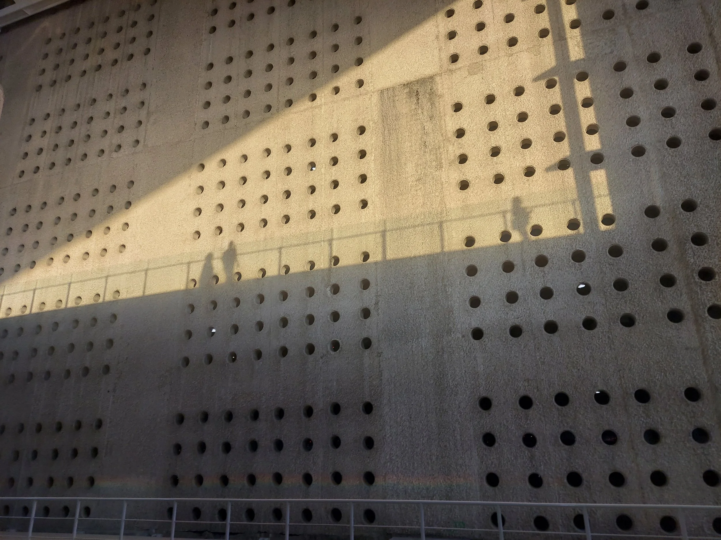 Pedestrian shadows on perforated concrete, Benito Juarez International Airport, Mexico City, Mexico