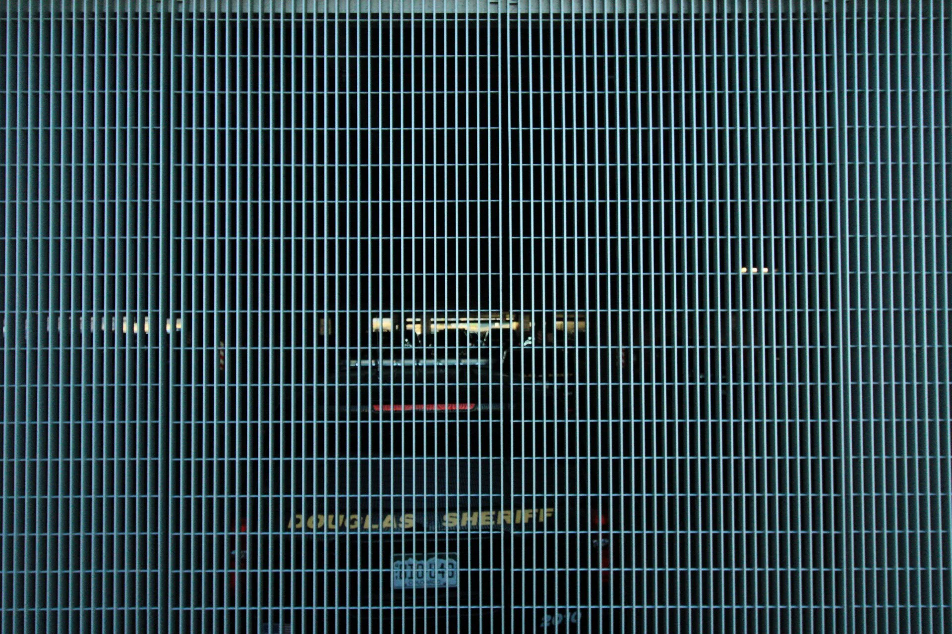 Douglas County Sheriff cruiser behind grid gate, Castle Rock, CO