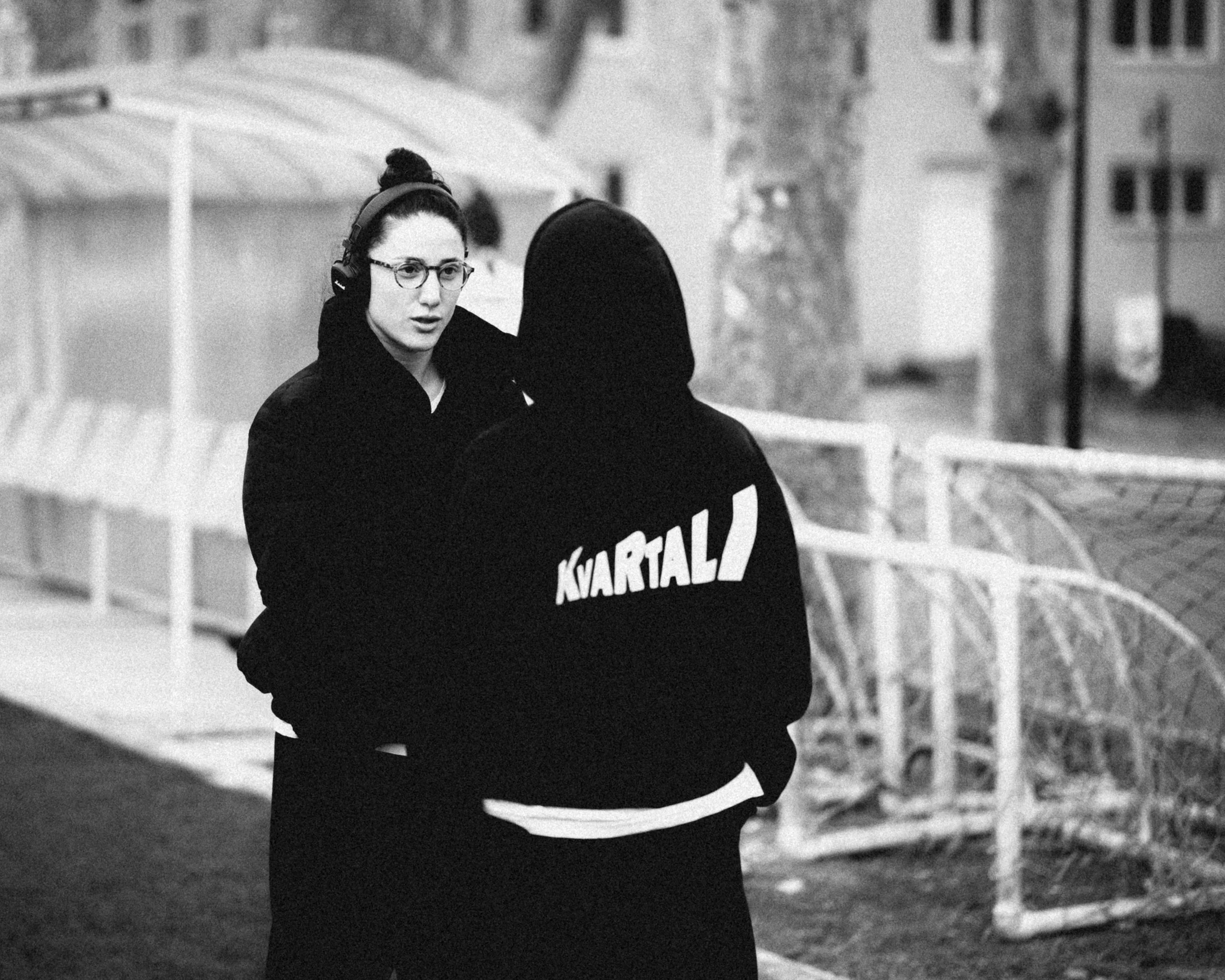 Nino Pasikashvili, the club captain, talking to someone wearing a Kvartali hoodie. November 2023.