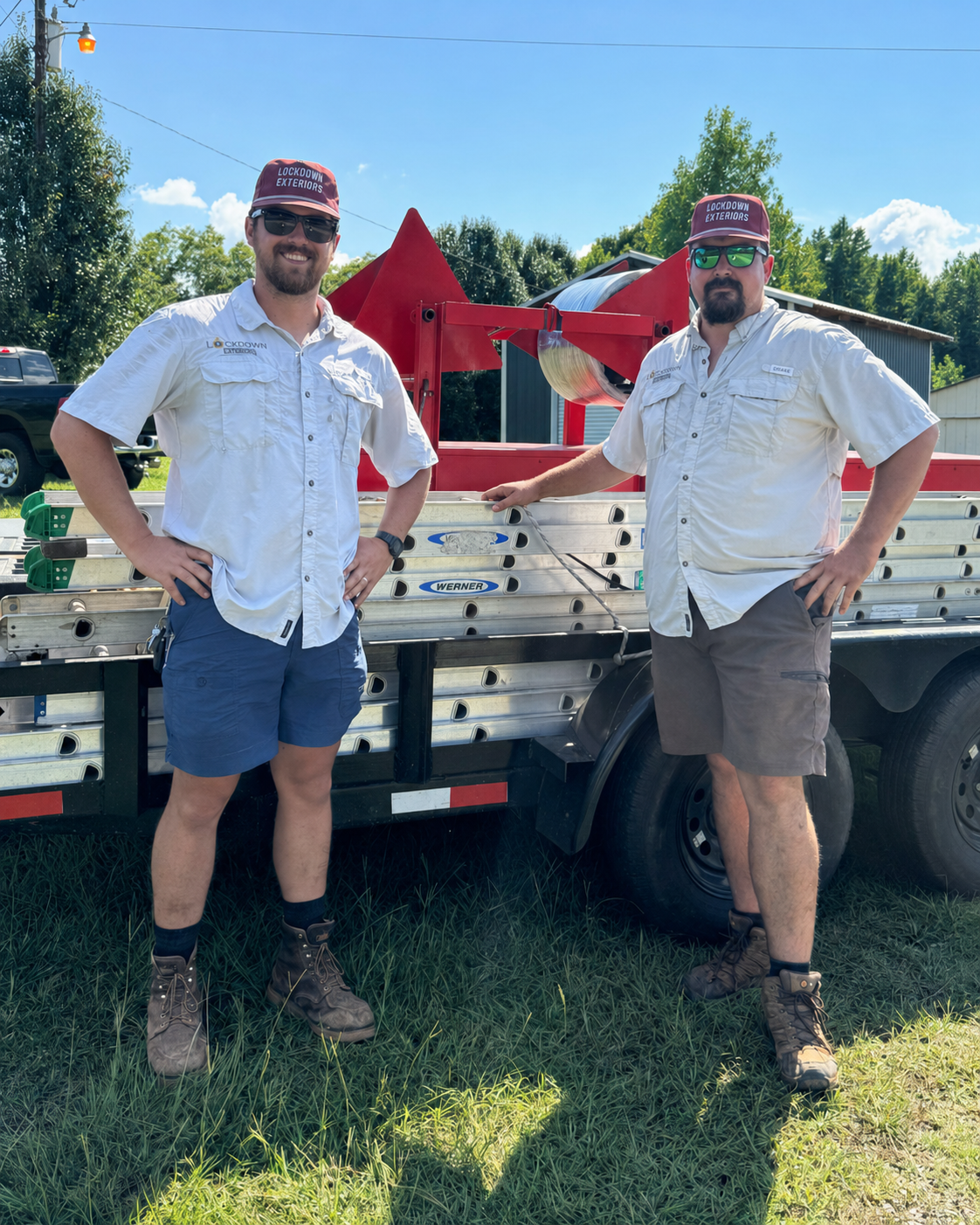 Allen and Jarod, the owner-operated Lockdown Exteriors crew, standing beside their work truck, ladders and seamless gutter equipment.