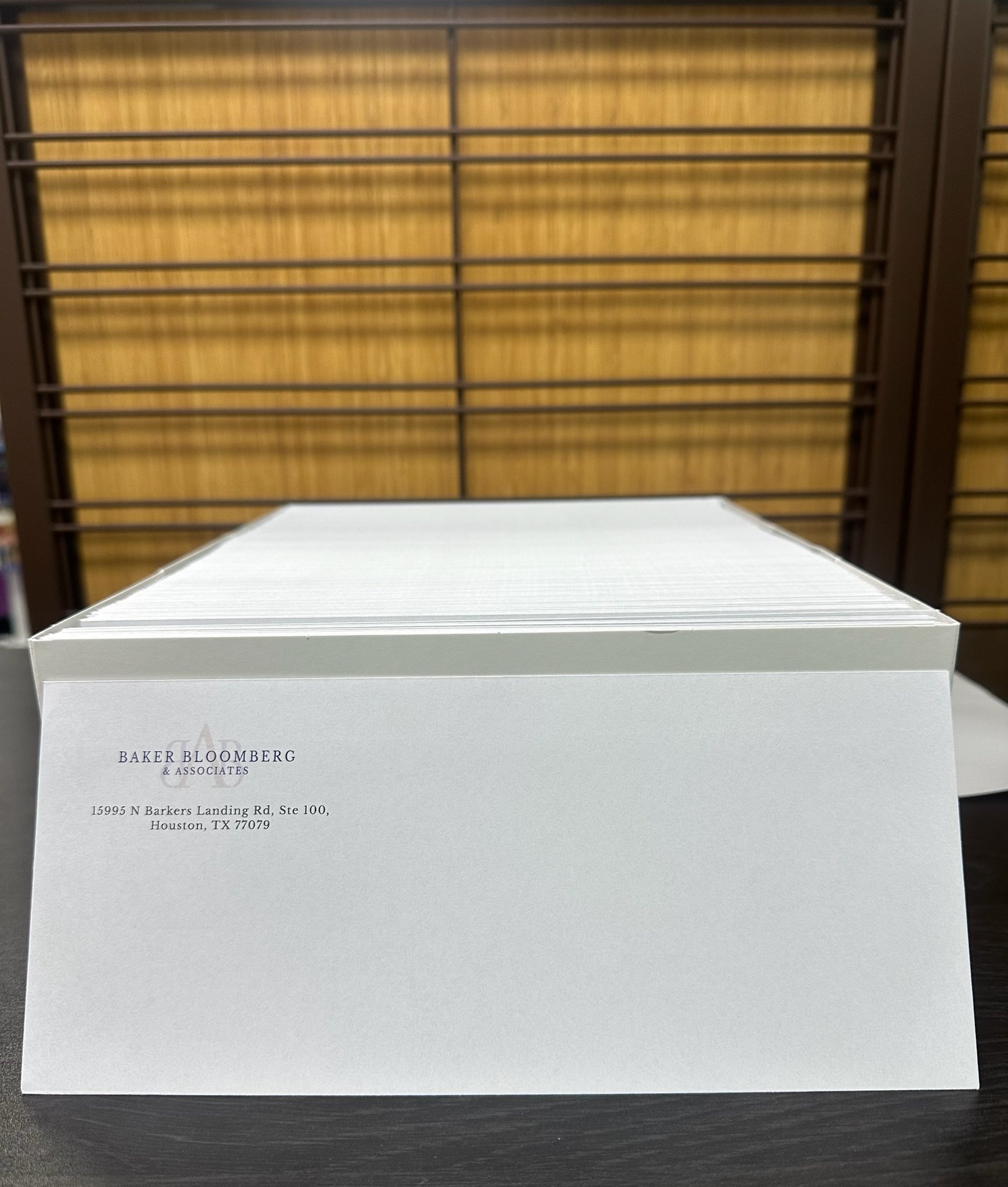 Custom printed business envelopes in Houston, TX by Memorial Postal Center featuring professional company branding and return addresses.