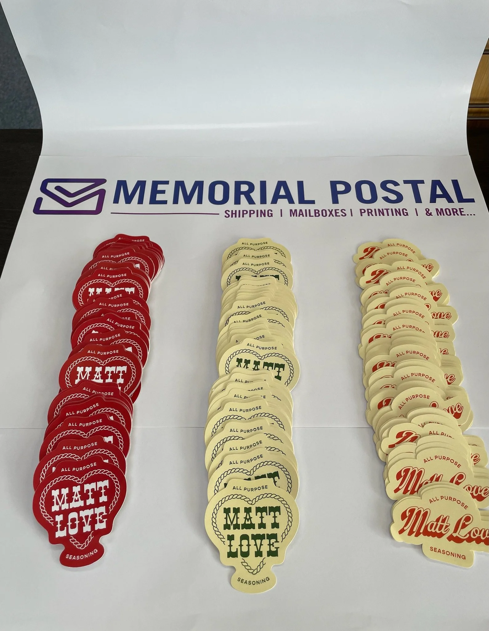 Custom die-cut sticker printing in Houston, TX by Memorial Postal Center featuring personalized shapes, logos, and business branding.