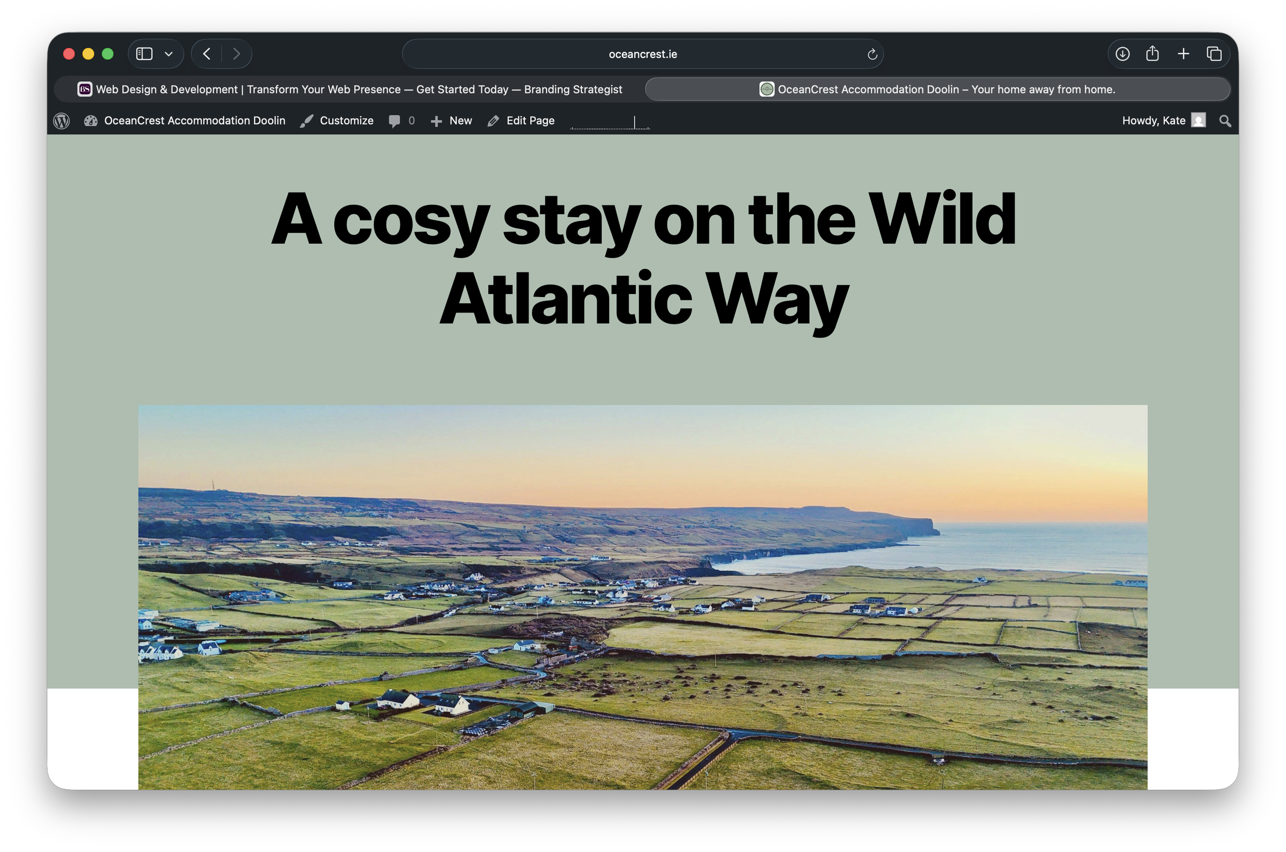 Web page with a large headline reading 'A cozy stay on the Wild Atlantic Way' and an aerial view photograph of a seaside landscape with green fields, small houses, coastline, and cliffs at sunset.