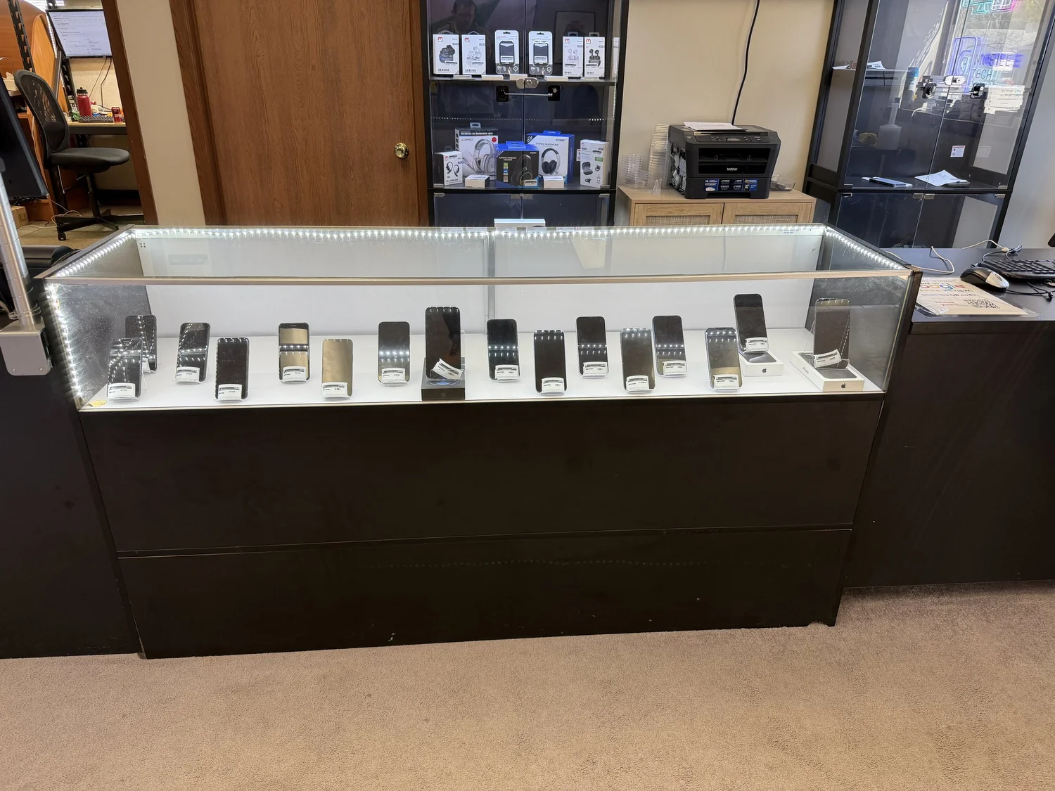 Phones and electronics displayed inside the Mobile Tech Repair shop in Appleton