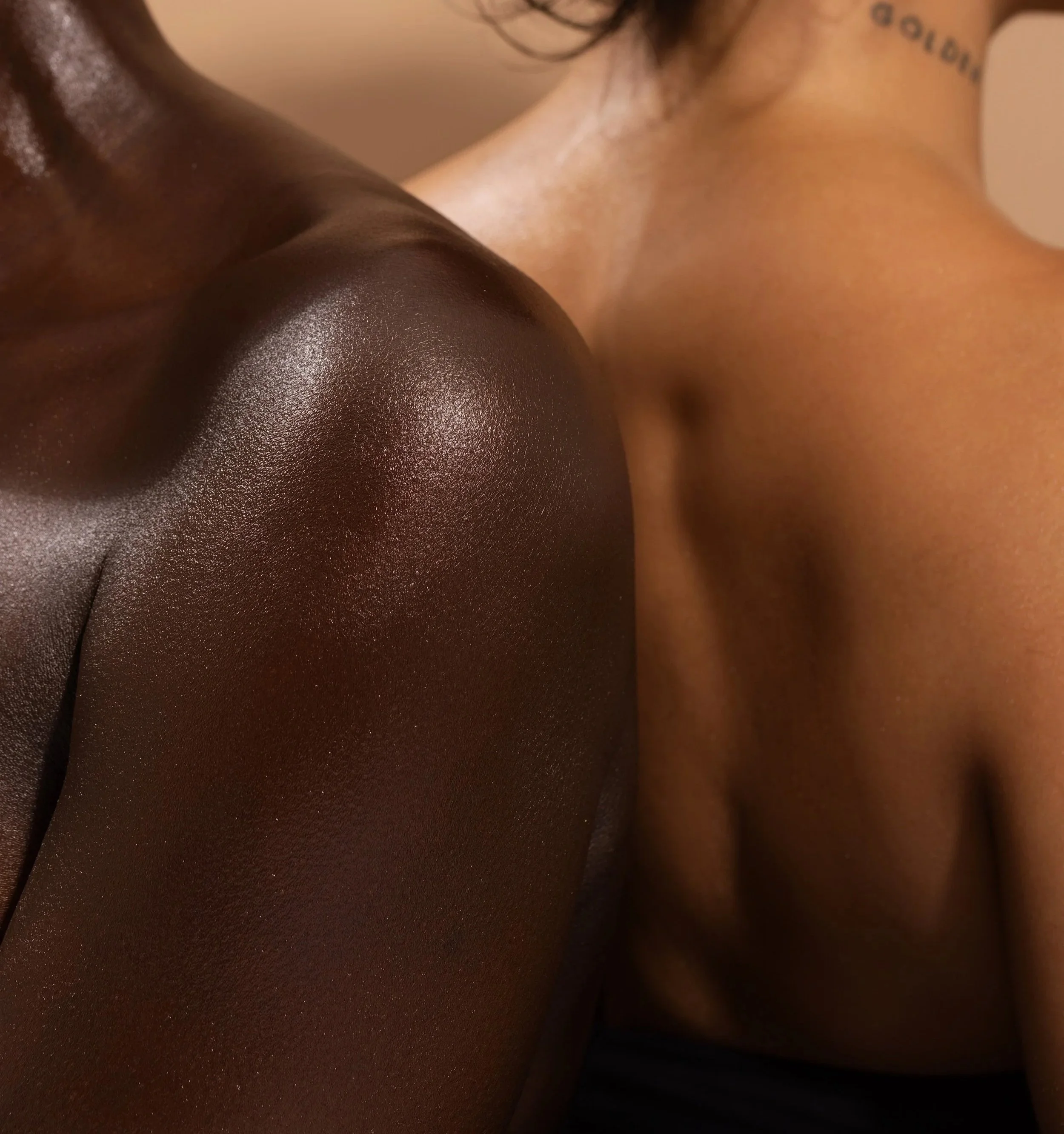Close-up of a person's cleavage, showing smooth, glistening skin from a slightly elevated angle.