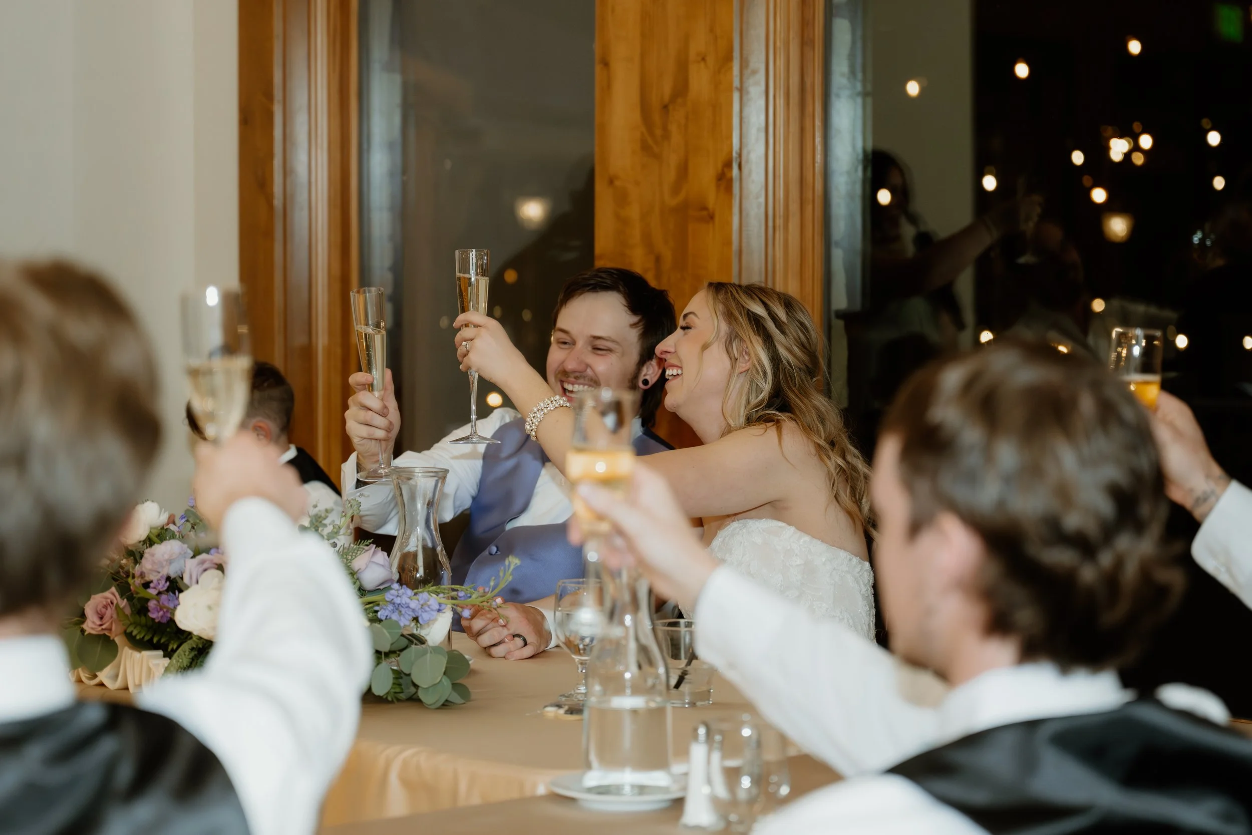 Bride and groom toasting during speeches at Della Terra Mountain Chateau in Estes Park