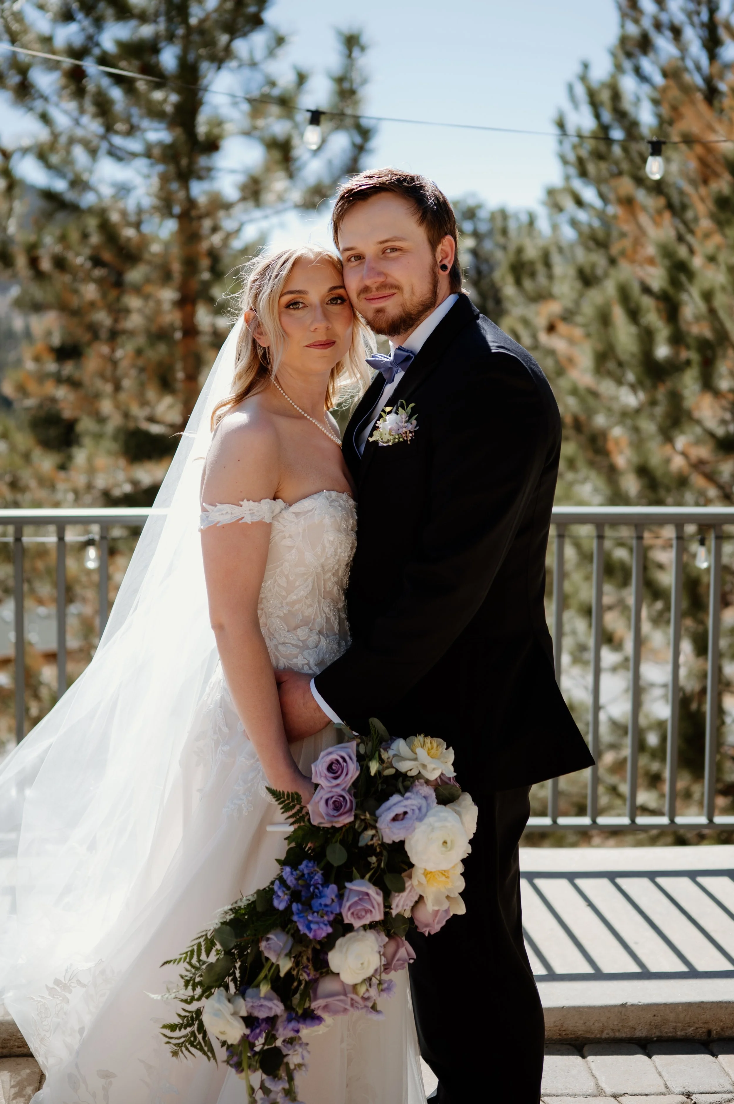 Bride and groom during golden hour at Della Terra Mountain Chateau in Estes Park, lilac and sage green wedding colors, march wedding.