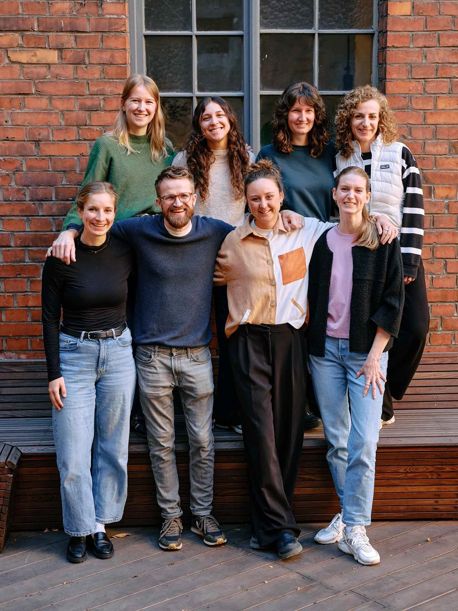 Gruppenfoto des PAN DACH Teams vor einer Backsteinfassade