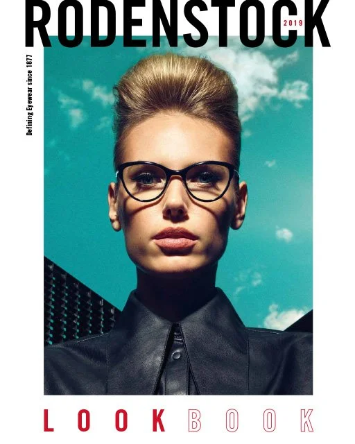 Cover des Rodenstock Lookbooks 2019 mit Frau in schwarzer Bluse und Rodenstock Brille vor blau-wolkigem Himmel, umgesetzt von imagespy.