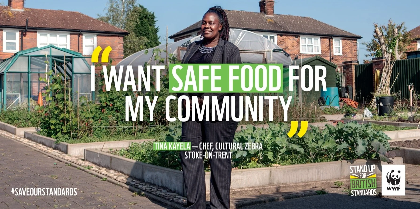 A woman stands in a community garden with text overlay saying, "I want safe food for my community." The background shows vegetable plots and residential houses. There is a hashtag #saveourstandards, and logos for "Stand Up for British Standards" and WWF.