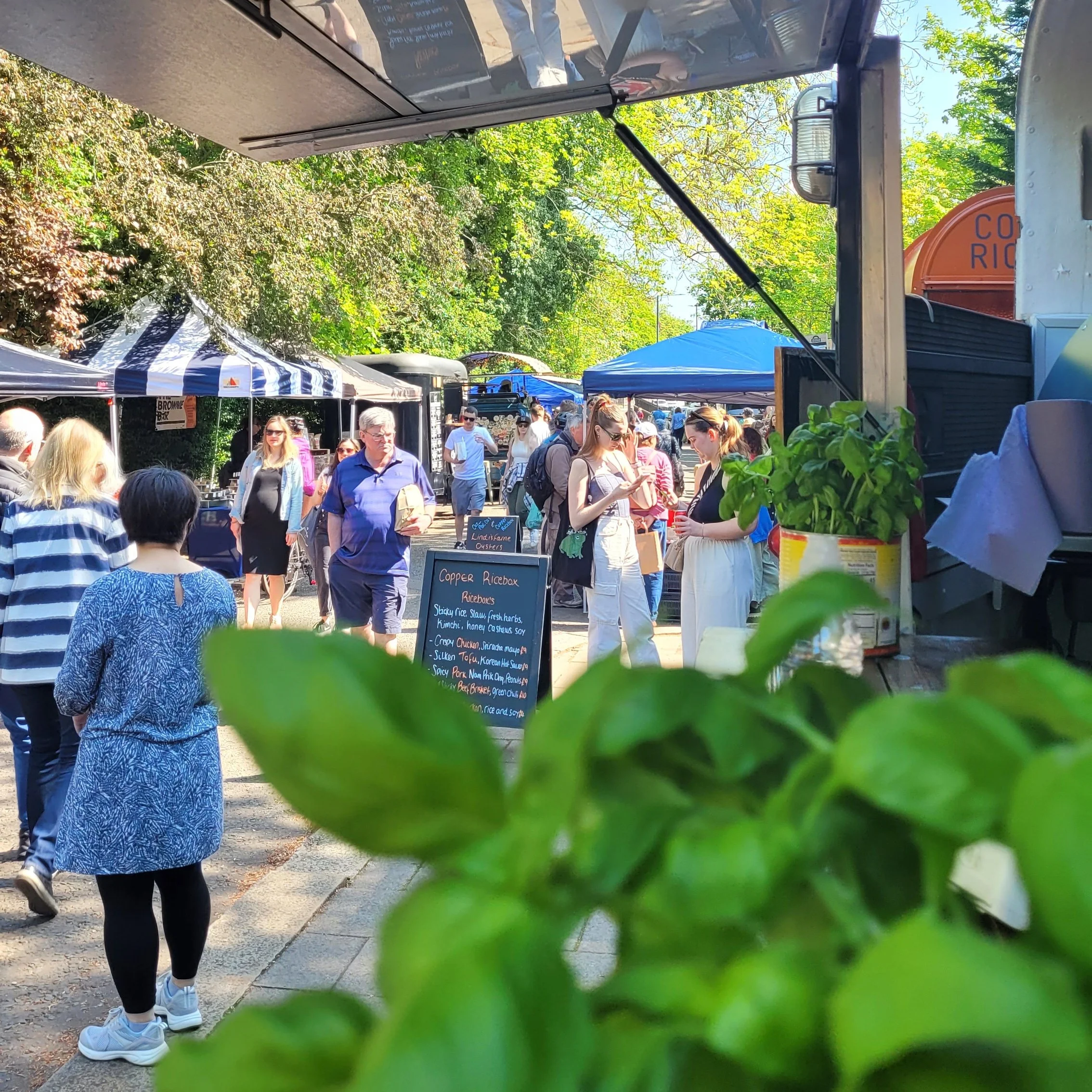 Market stalls and people walking across Armstrong Bridge in Jesmond