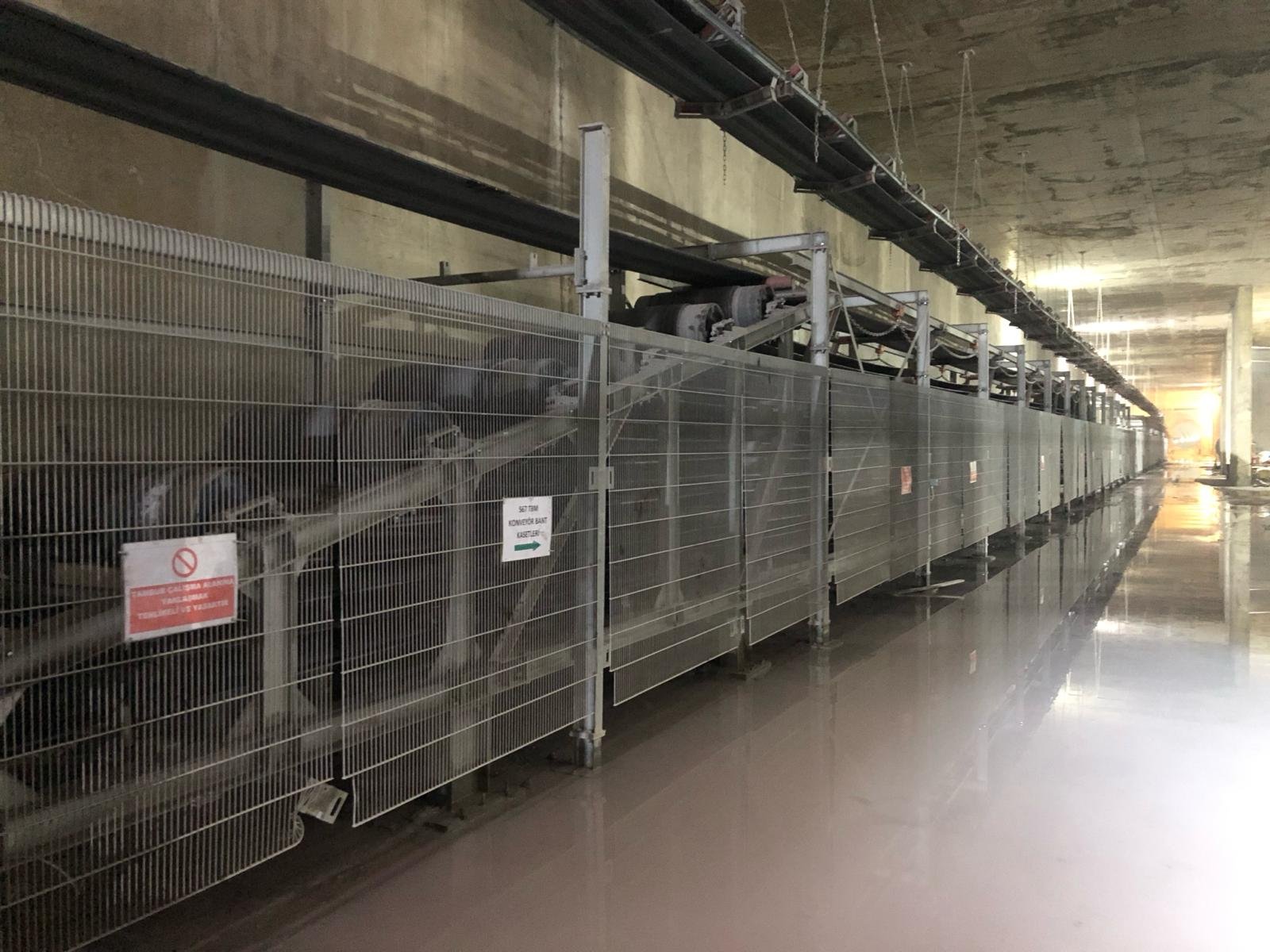 Underground tunnel construction with metal fencing and machinery