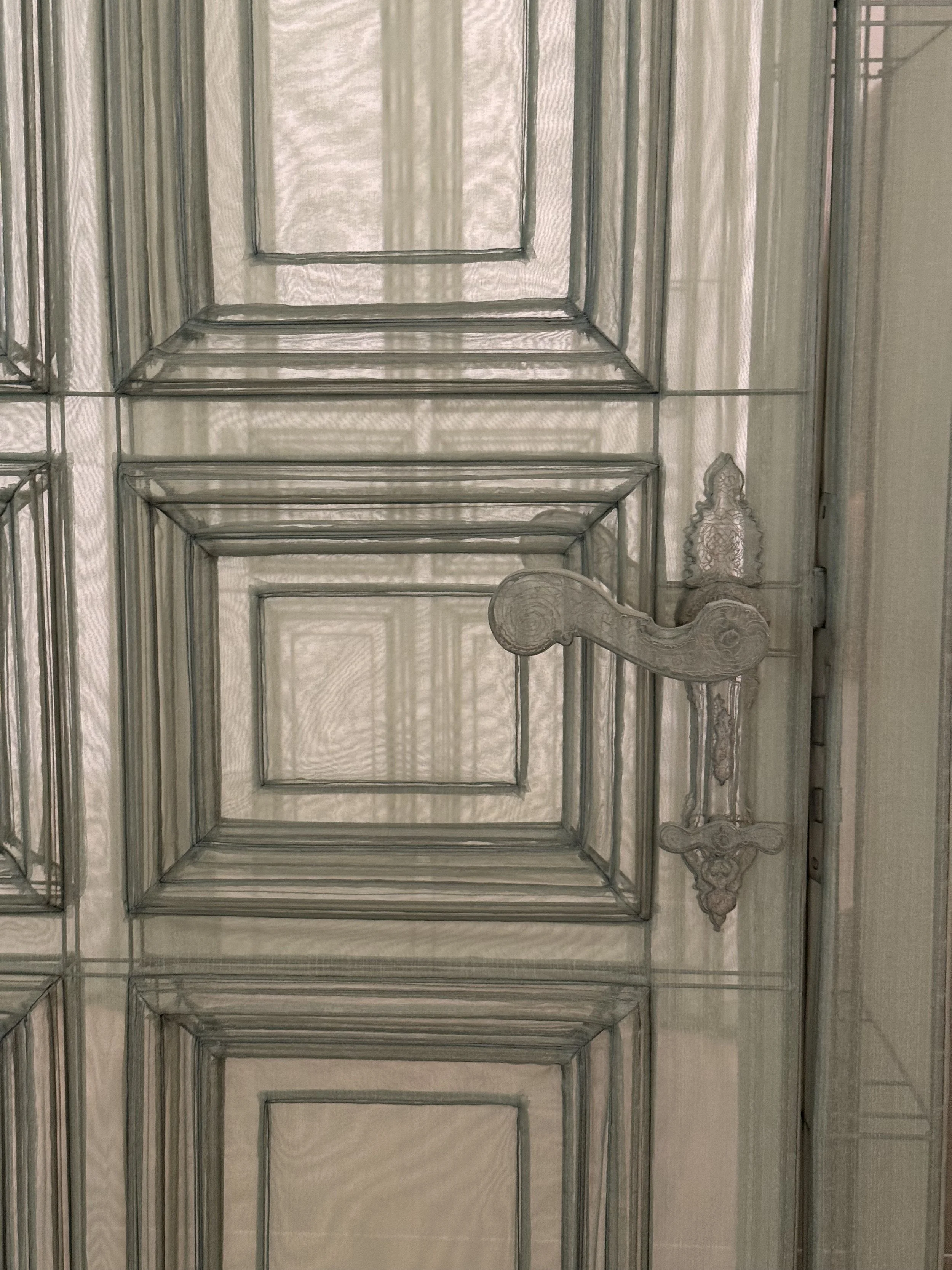 Close-up of a translucent fabric door and handle in Do Ho Suh’s architectural installation at MMCA Seoul.