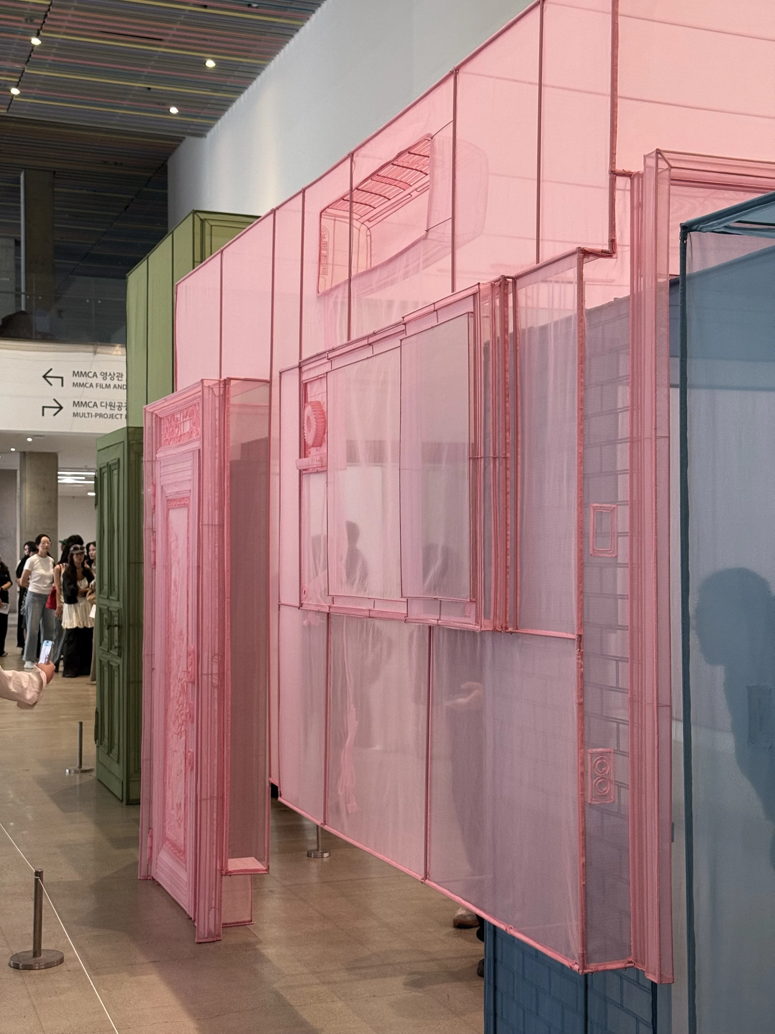 Do Ho Suh’s translucent fabric architecture in green, pink, blue and yellow installed at MMCA Seoul.