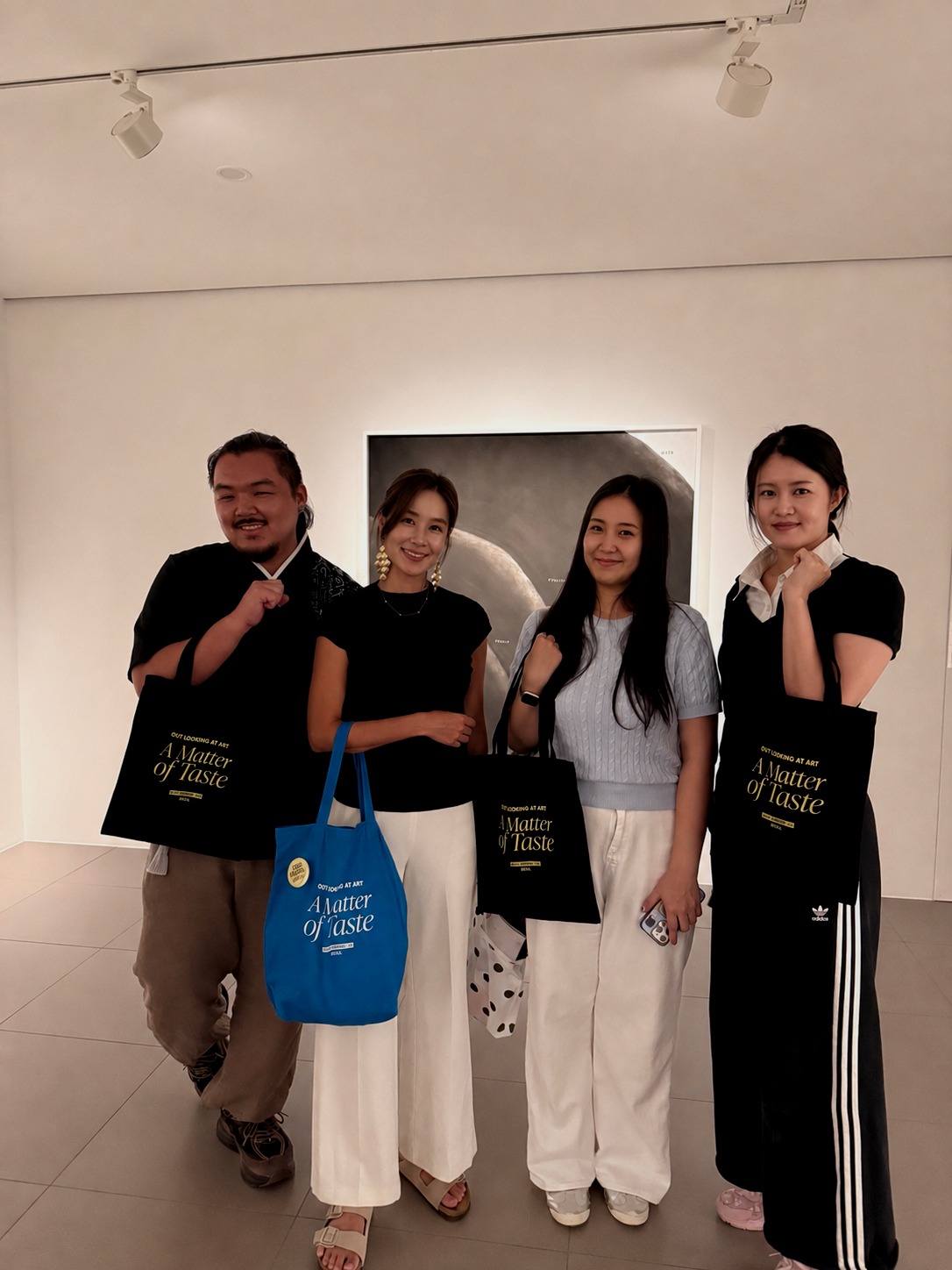Participants posing together at a contemporary art gallery during Tasty Morsels Art’s Samcheong Night art walk in Seoul, 2026.