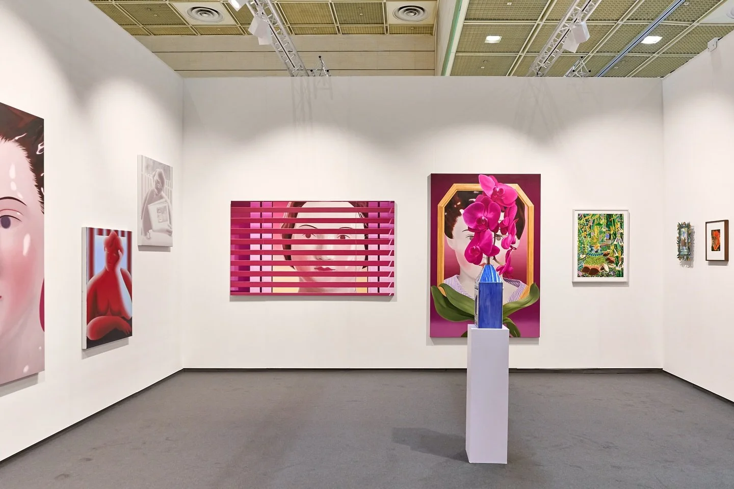 Booth view at Frieze Seoul featuring works by ThisWeekendRoom Gallery, including figurative paintings in red, pink, and monochrome tones and a blue house-shaped sculpture.