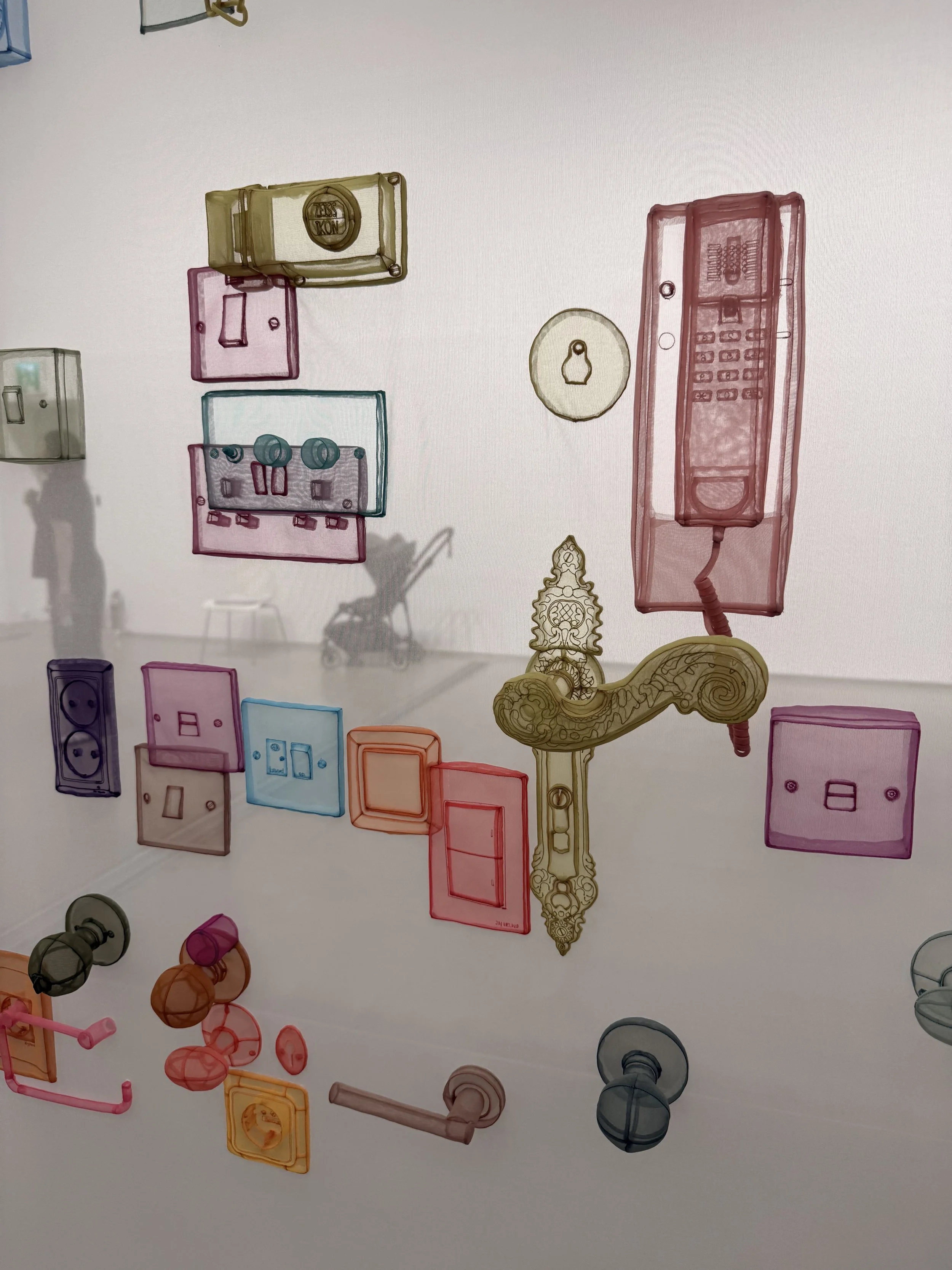 Colorful translucent fabric reproductions of door handles, light switches, sockets and other household fixtures in Do Ho Suh’s installation at MMCA Seoul.