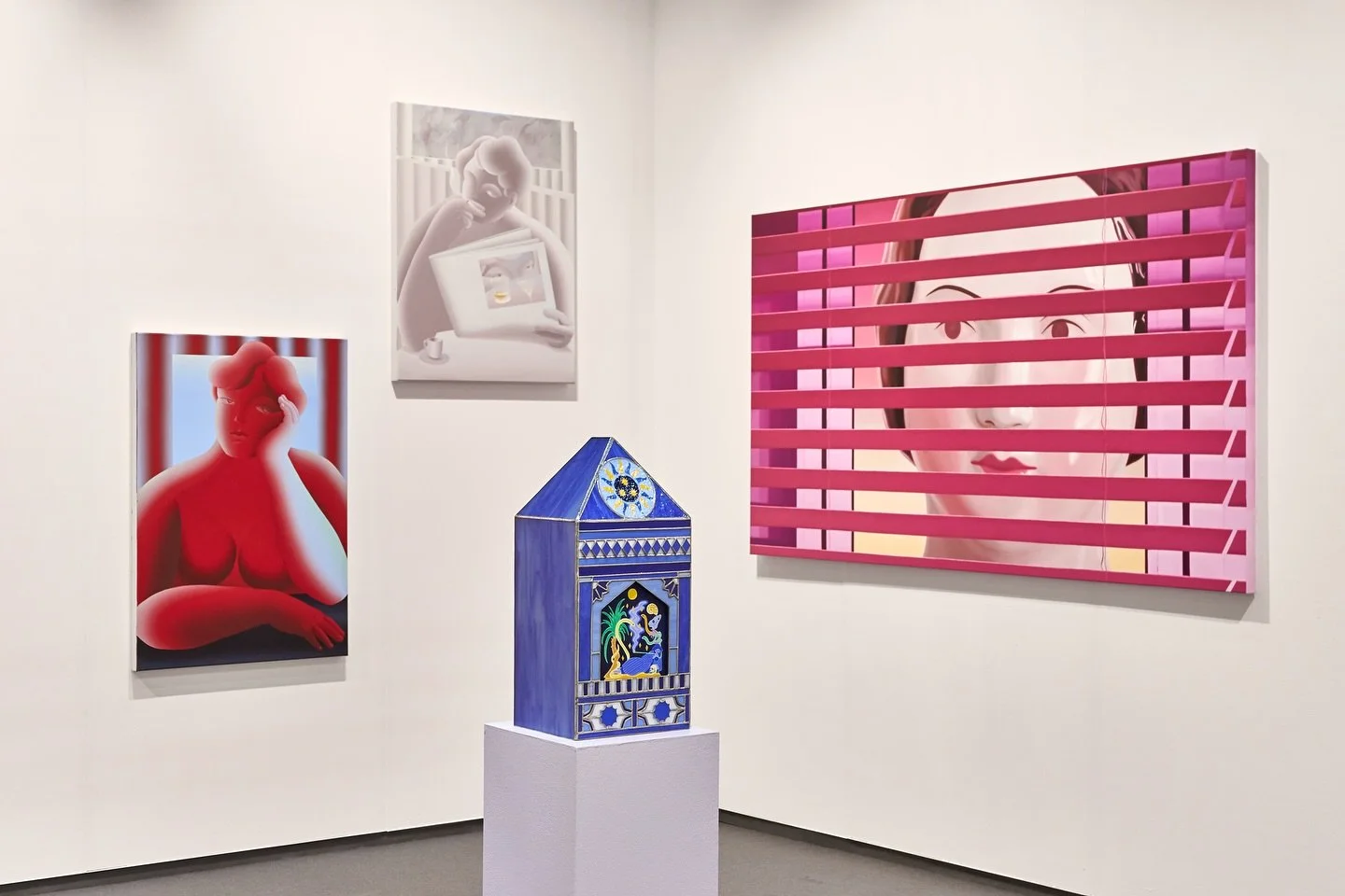 Booth view at Frieze Seoul featuring works by ThisWeekendRoom Gallery, including figurative paintings in red, pink, and monochrome tones and a blue house-shaped sculpture.