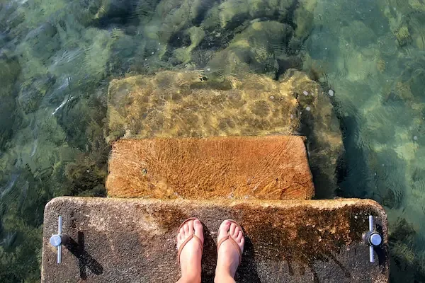 stairs going down to water, presence of feet