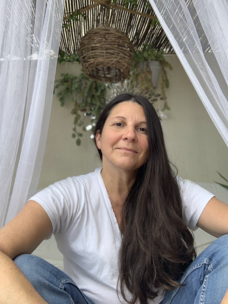 Gwenaelle Maldue sitting on a sofa outdoor