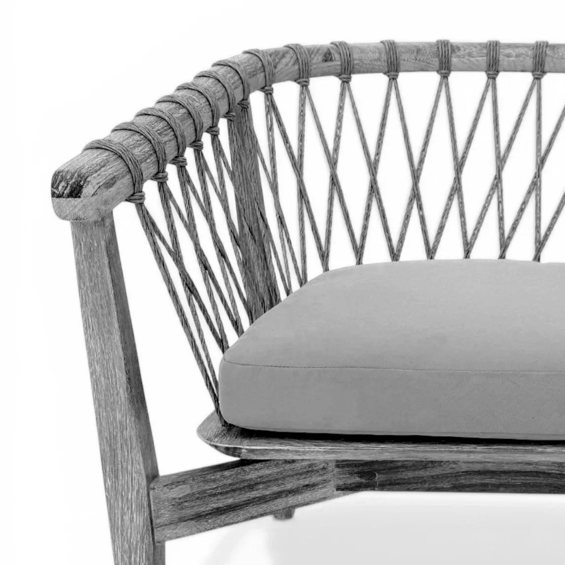 Close-up view of a wooden outdoor bench with a cushioned seat, featuring a woven rattan backrest and armrest.