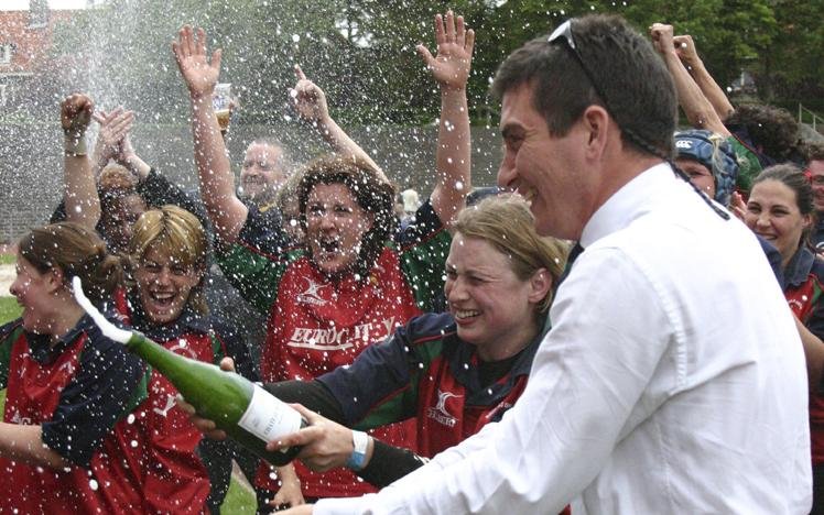 Group of people celebrating outdoors with champagne