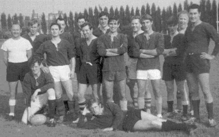 Vintage black and white photo of a rugby team posing on a field