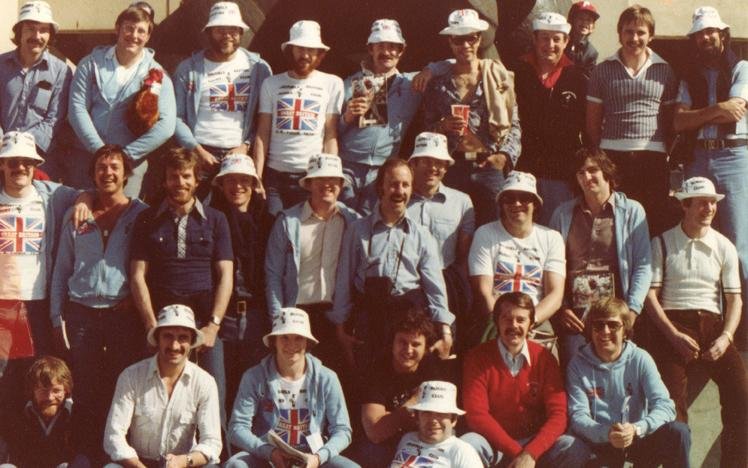 Group of people wearing British-themed clothing and hats