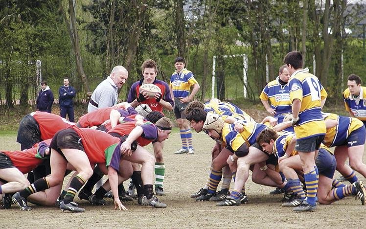 Rugby teams in a scrum on a field