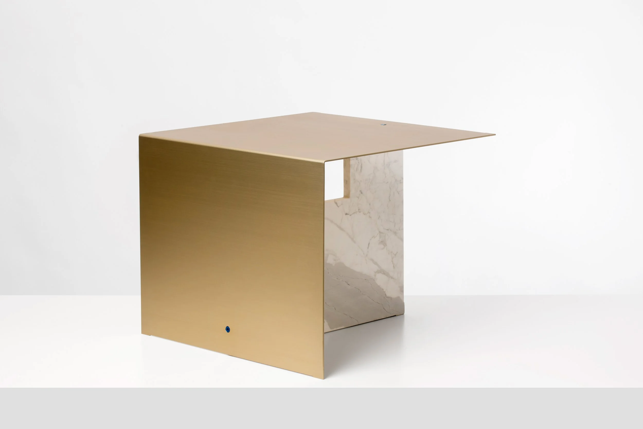 Minimalist desk with gold metallic front panel, marble side panel, and wooden top, set against a white background.