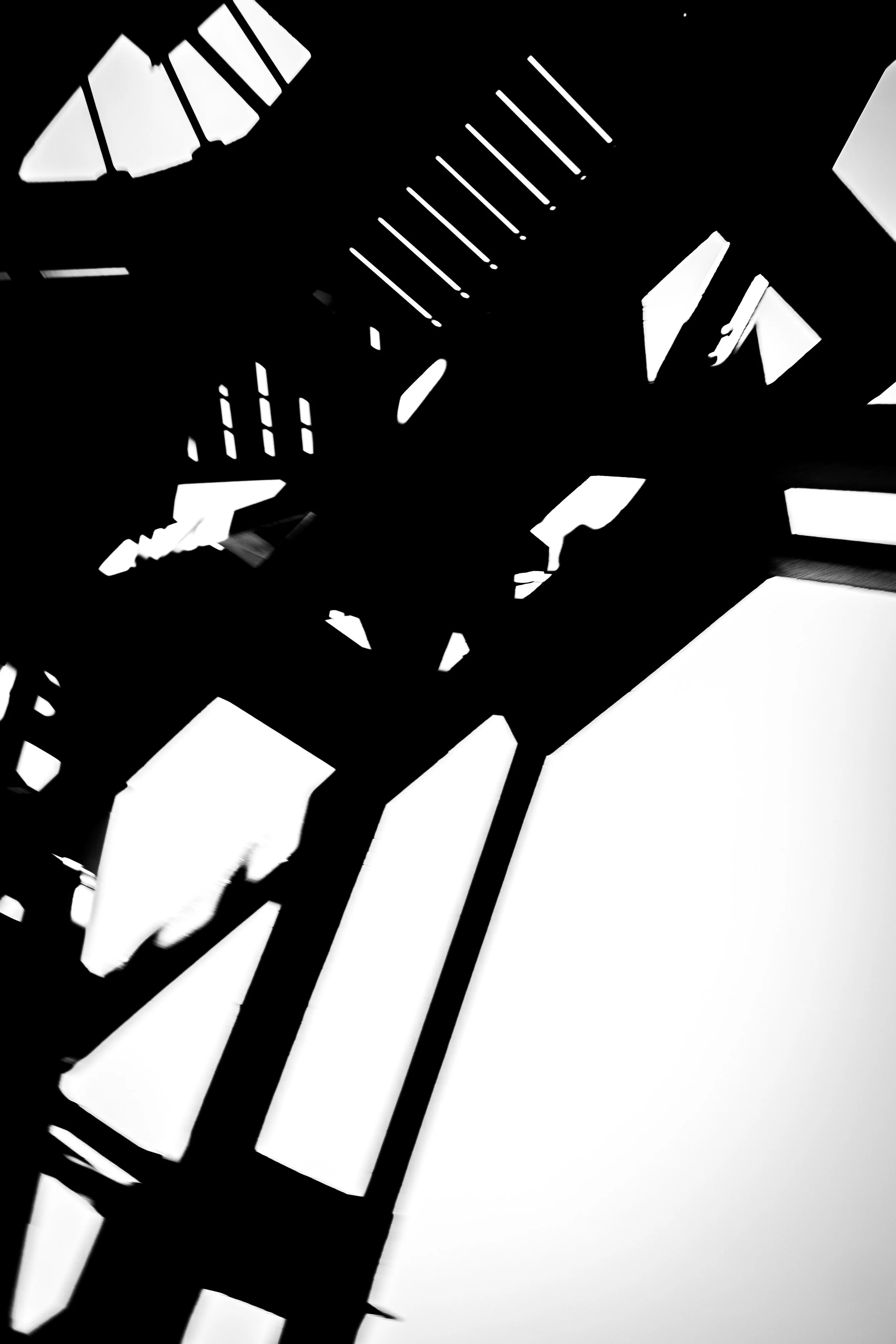 Close-up of a black and white patterned object featuring stripes and abstract shapes.