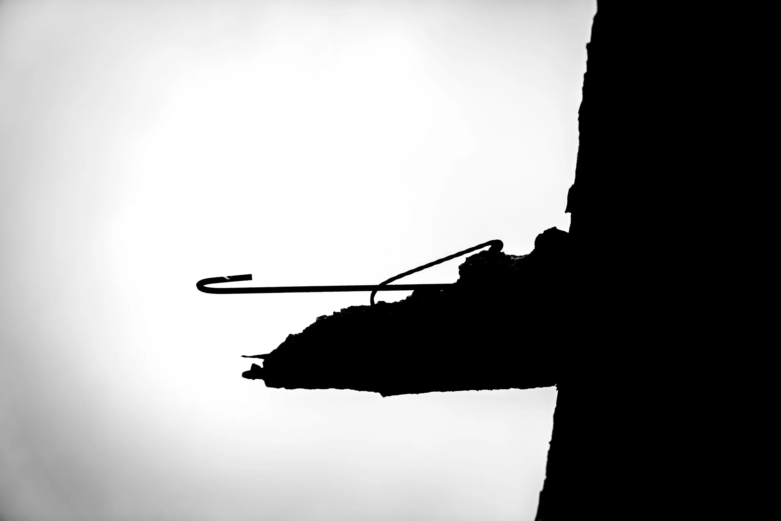 Silhouette of a building against a white sky.