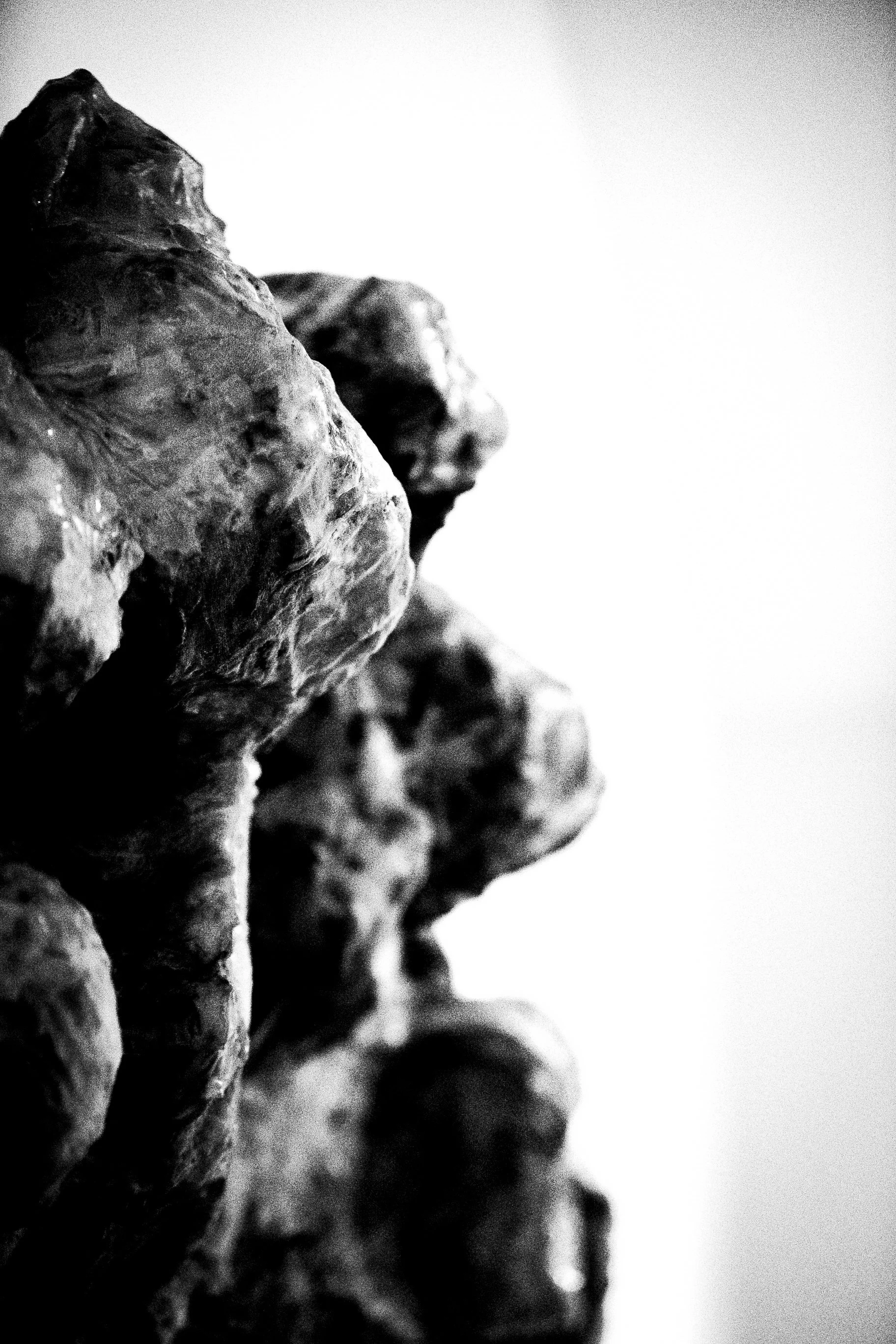Close-up of rough, textured rocks in black and white.
