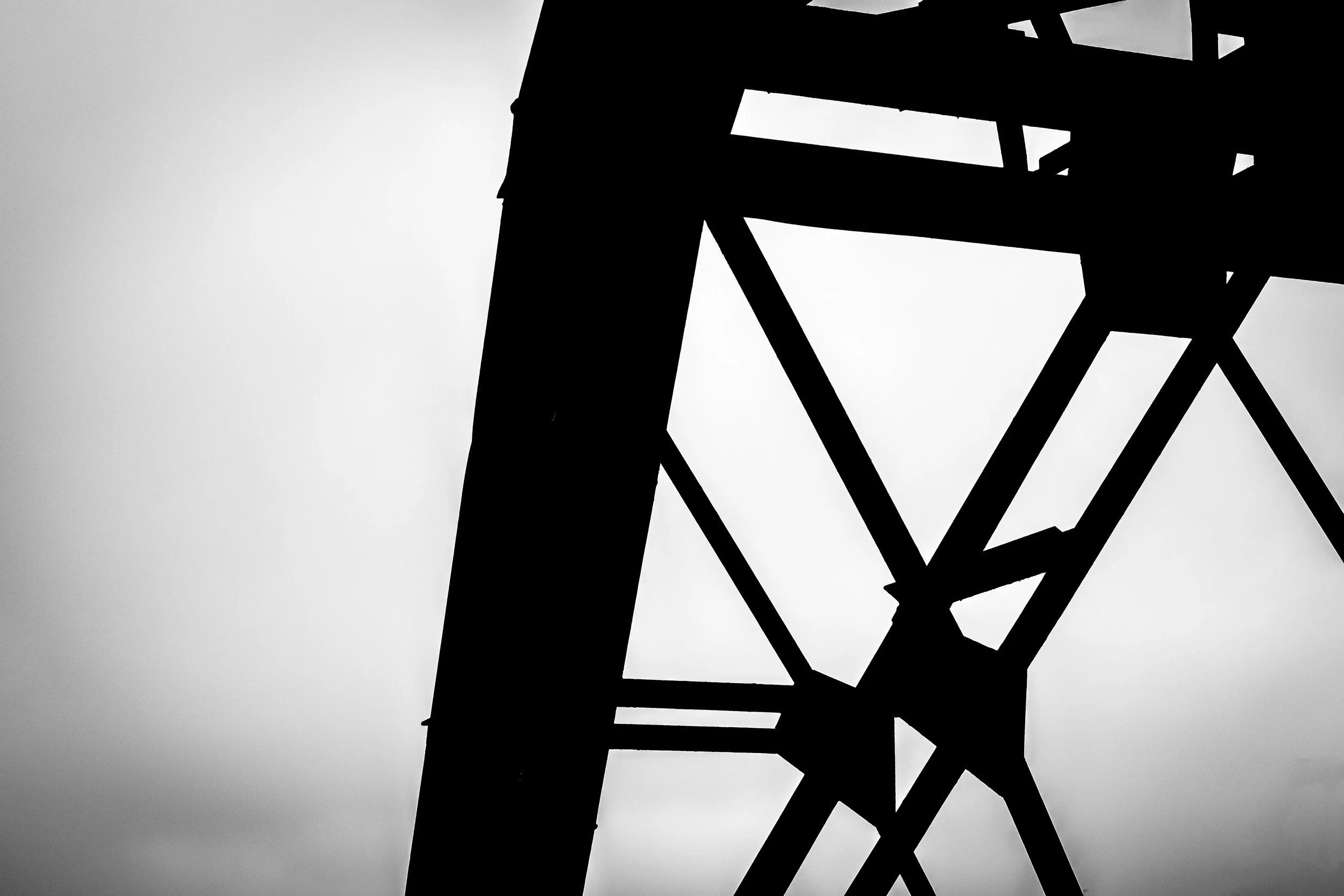 Silhouette of a tall tower or structure against a cloudy sky.