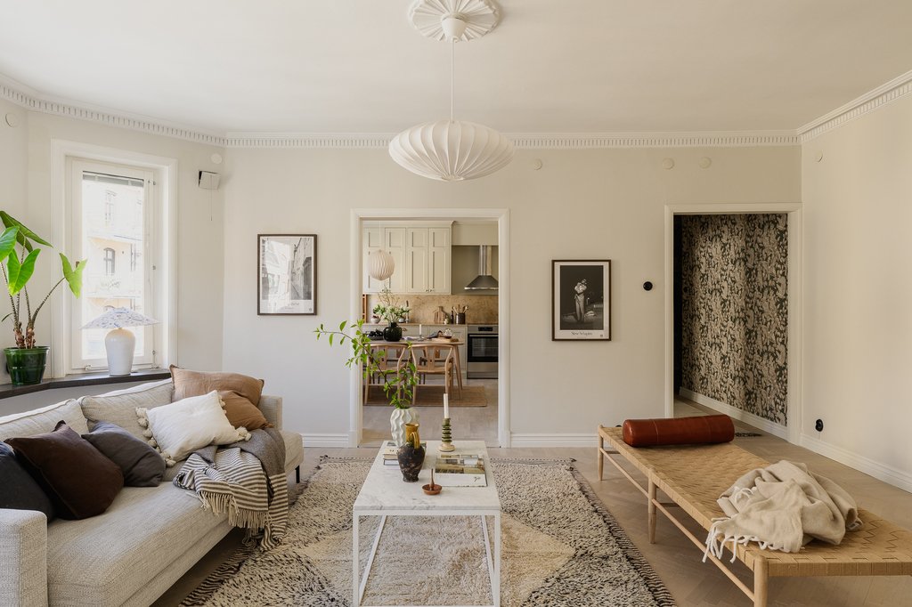 Inviting Scandinavian Living Room with Layered Rugs and Neutral Tones