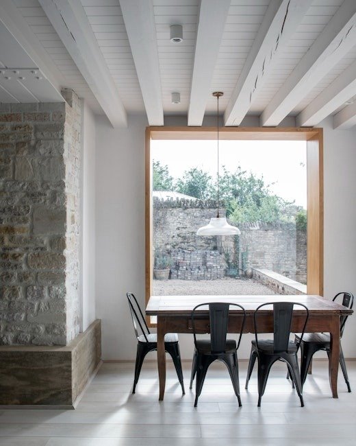 interior-dining-nook-stone-walls-modern-frame-window-parchment-works.jpg