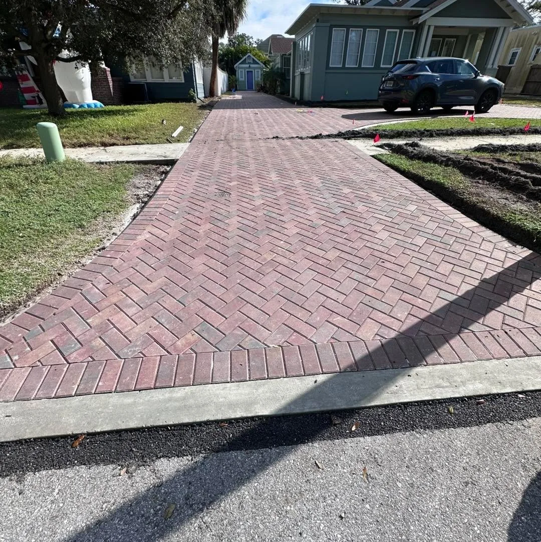 New driveway is in and it is beautiful!! It was a long process to get through permitting but we finally have a beautiful finished product. Now the fun begins- plants and plants going in Thursday and Friday! 

I highly recommend Gulfside Pavers for th