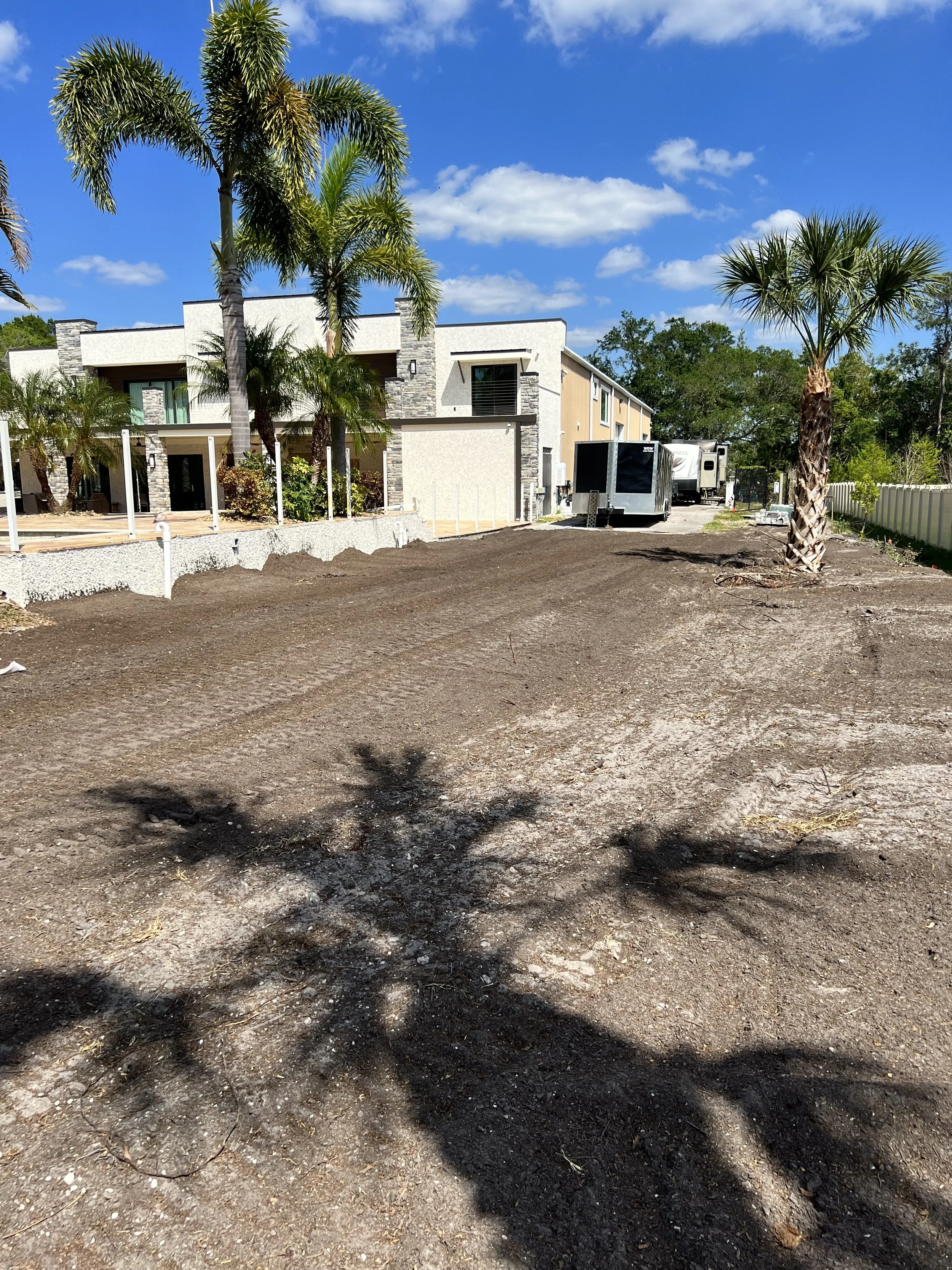 Grading the property so the water would flow away from the house. In Florida you have to prepare for torrential rain!