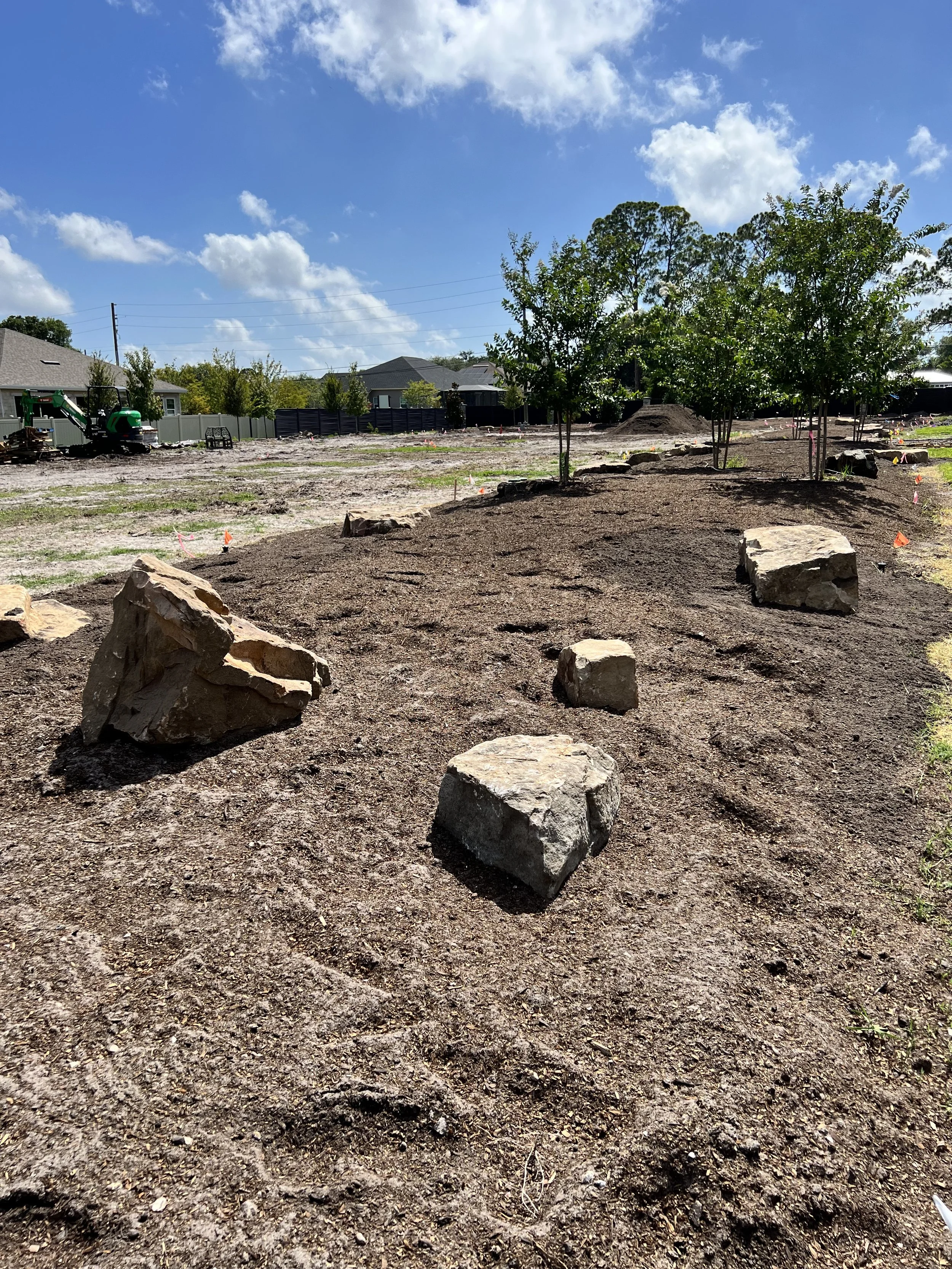 Rocks! We ended up installing over 100,000lbs of rocks in all the beds and berms!