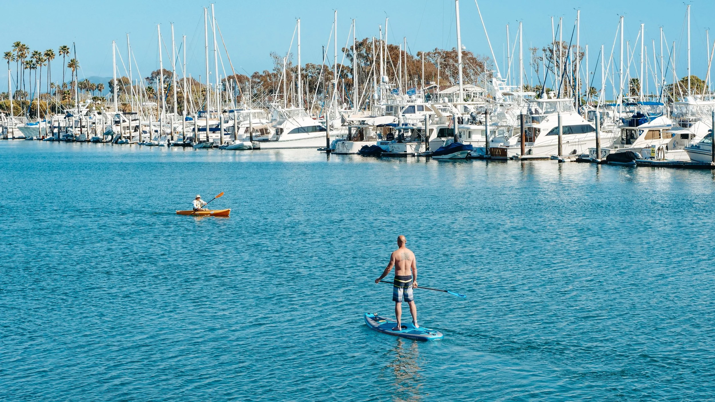 kayaking and paddleboarding on calm mission bay san diego california
