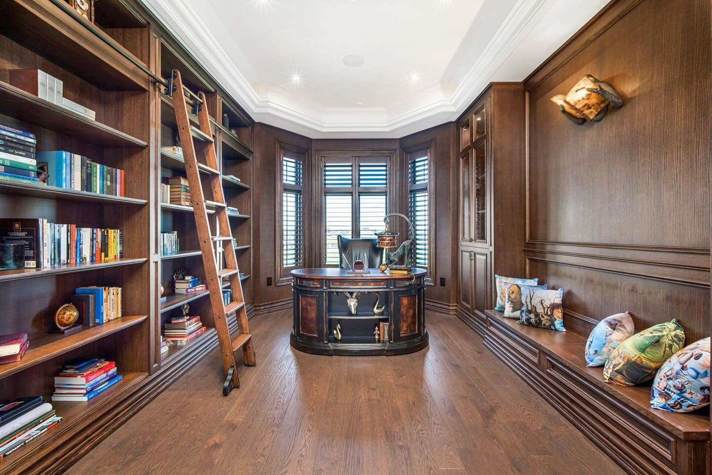 Step inside this timeless wood-paneled library, where every detail speaks to craftsmanship and elegance. From the rich textures of natural wood to the perfectly curated shelves, this room is built for relaxation, inspiration, and endless exploration.