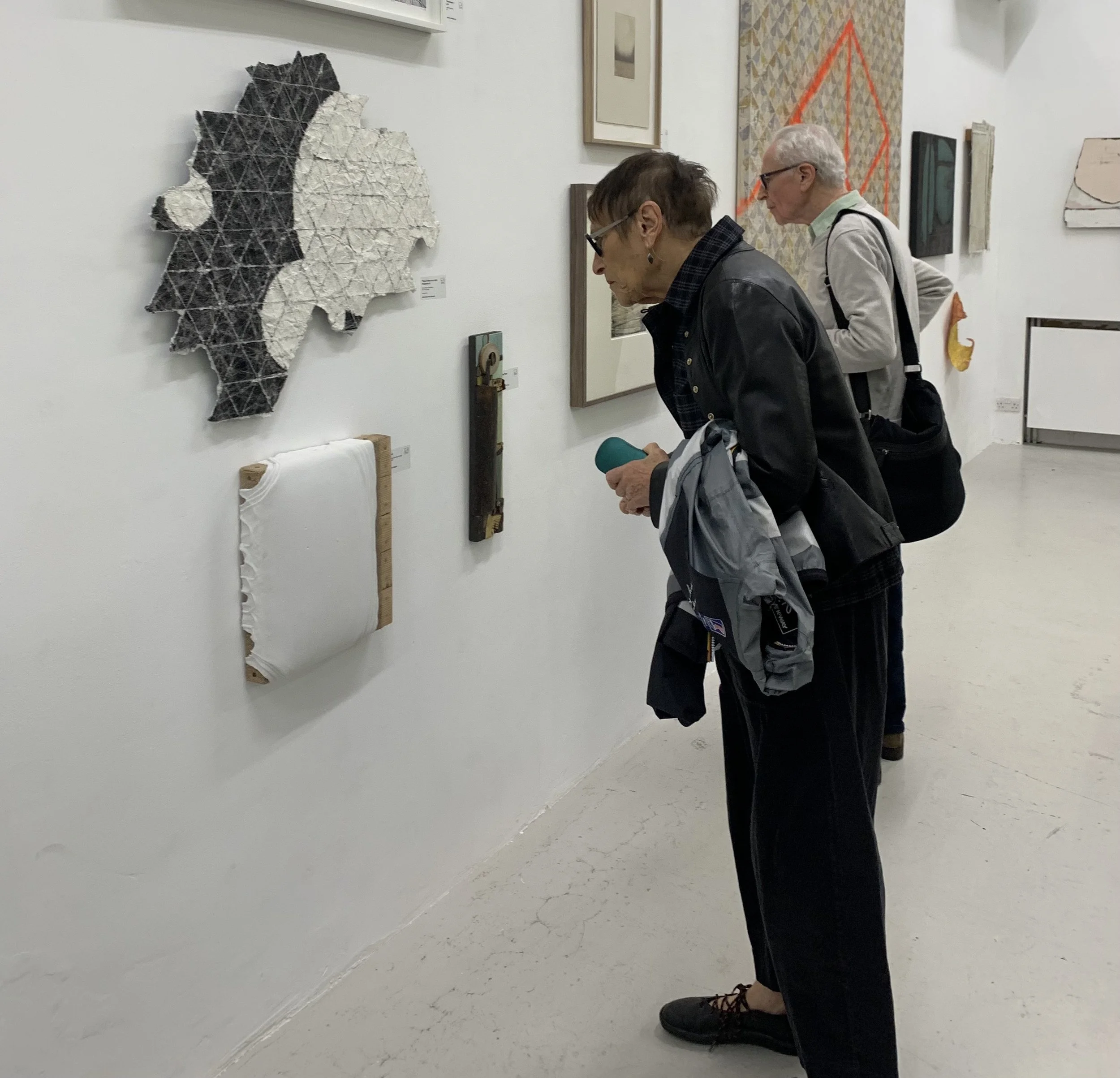 Visitors viewing works at No Place Art – Materiality, The Handbag Factory, London, 2026.