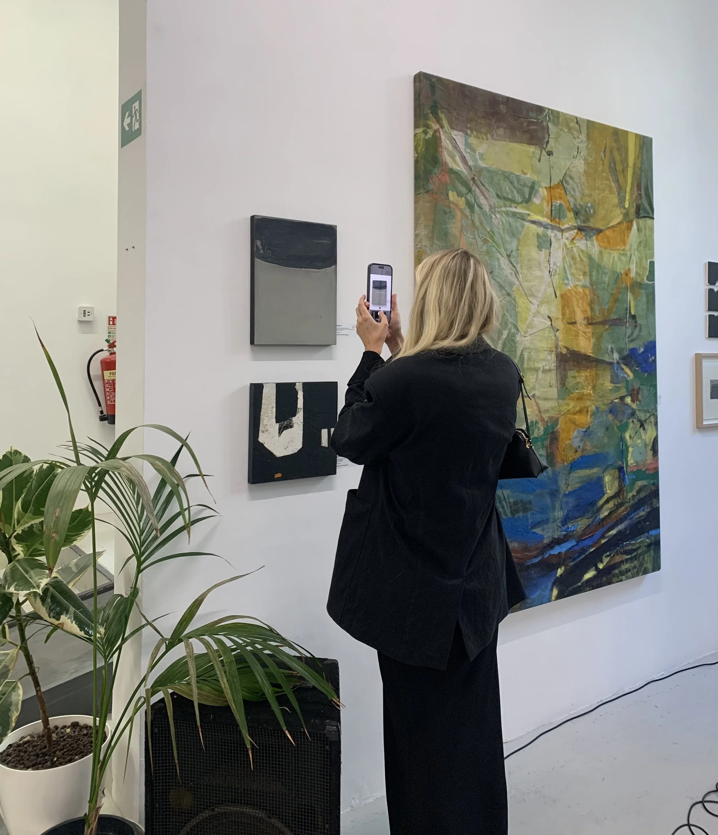 Visitor viewing Residue V by Ekaterina Galera at No Place Art – Materiality, London 2026.