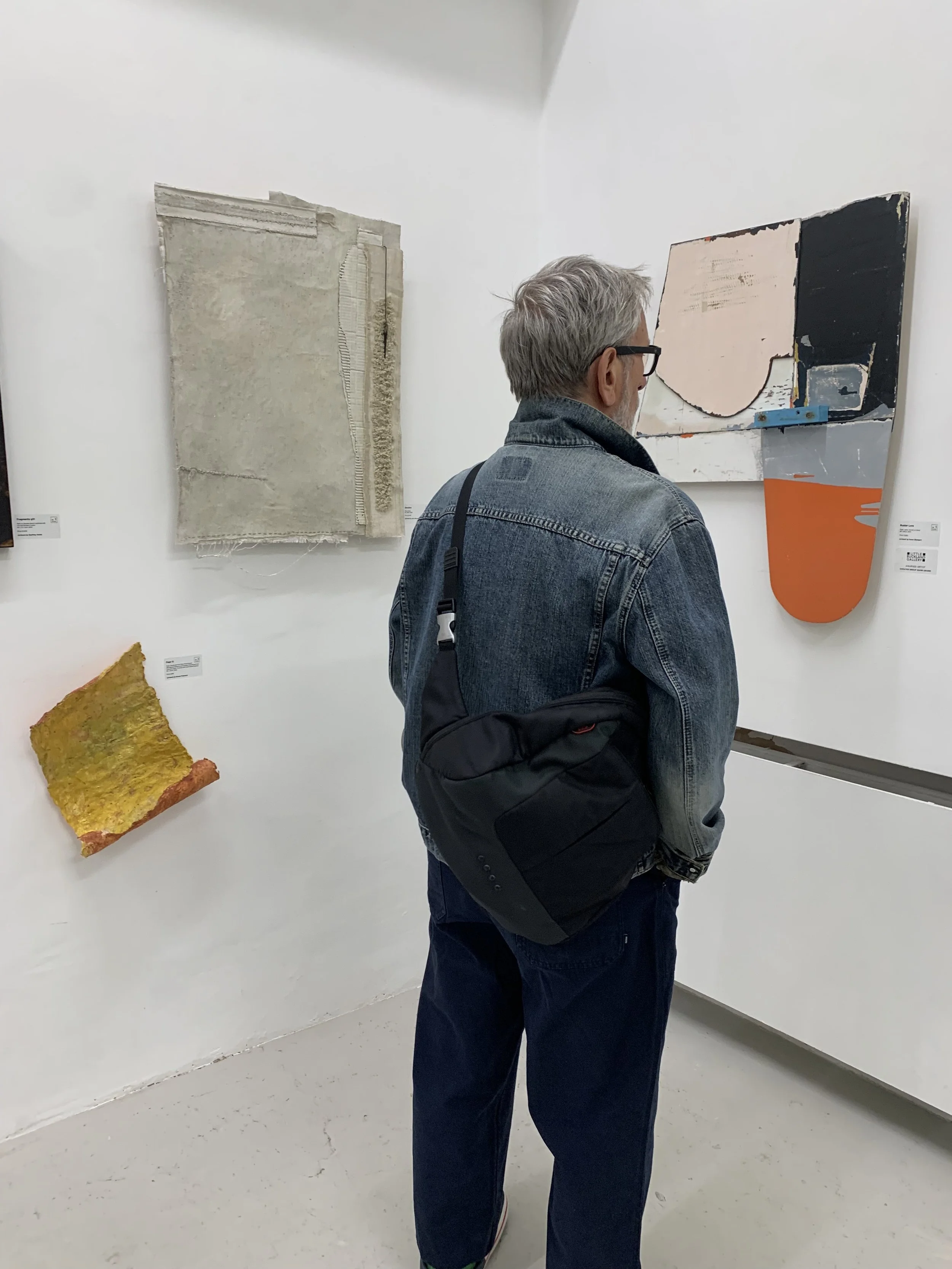 Visitors viewing artworks at No Place Art – Materiality, The Handbag Factory, London, 2026.