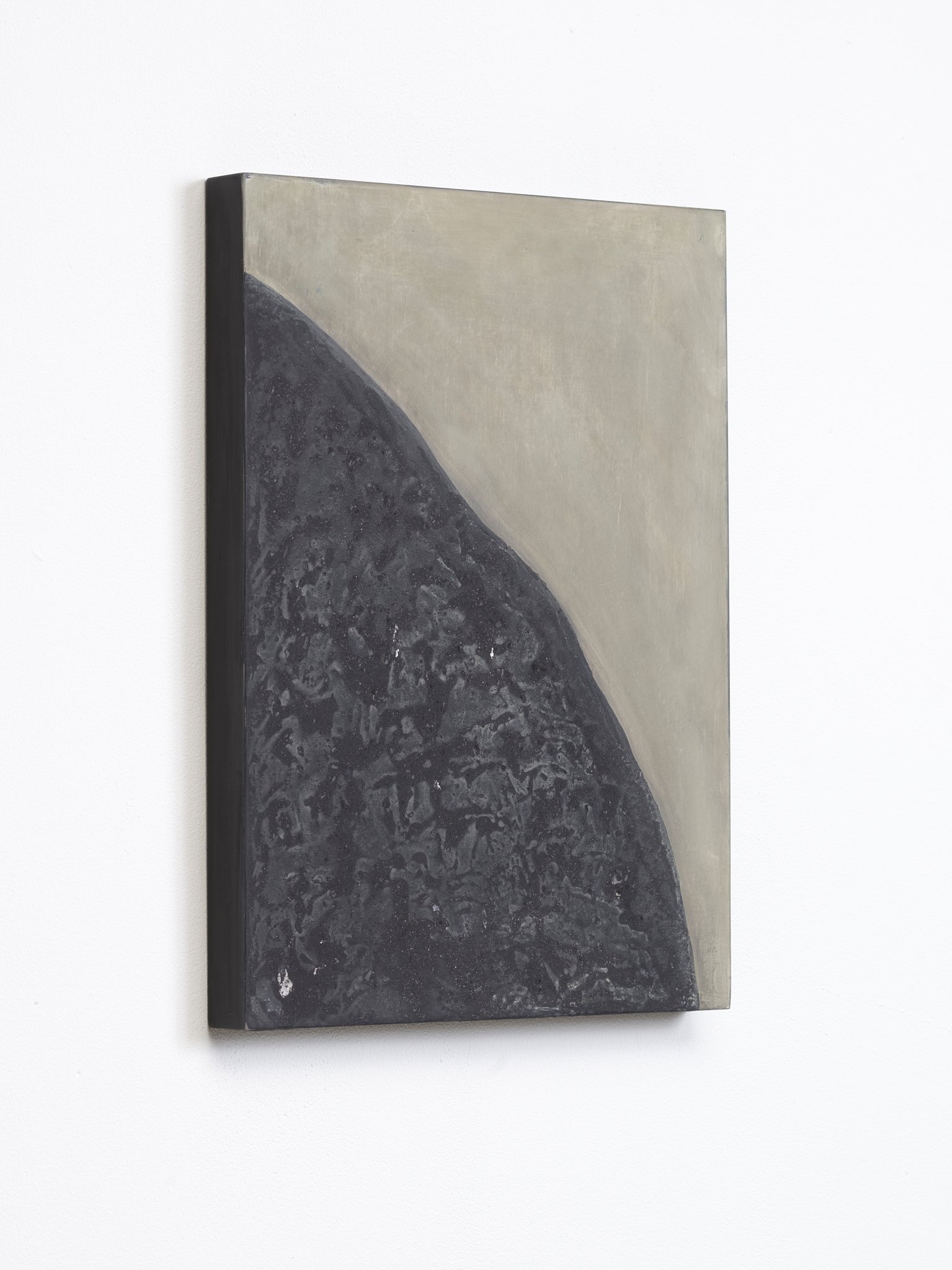 Close-up of a rectangular abstract painting with dark gray and beige colors, mounted on a white wall.
