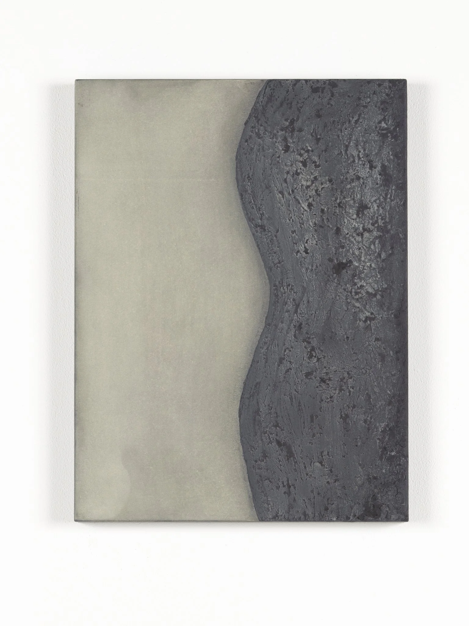 A ceramic tile displaying a wild landscape painting of a volcanic mountain with dark, textured rock formations and a shadowed silhouette against a light background.